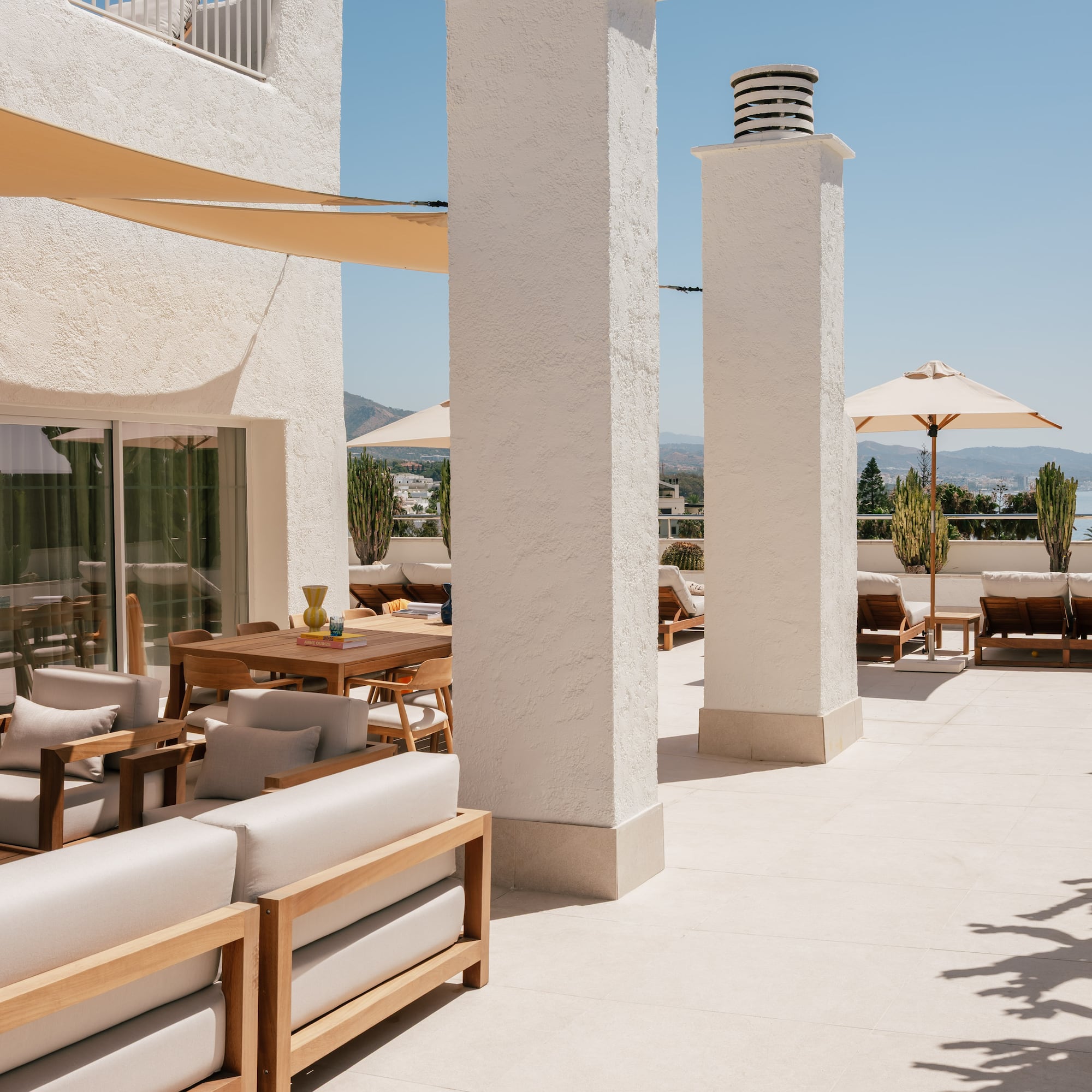 a patio with chairs and umbrellas