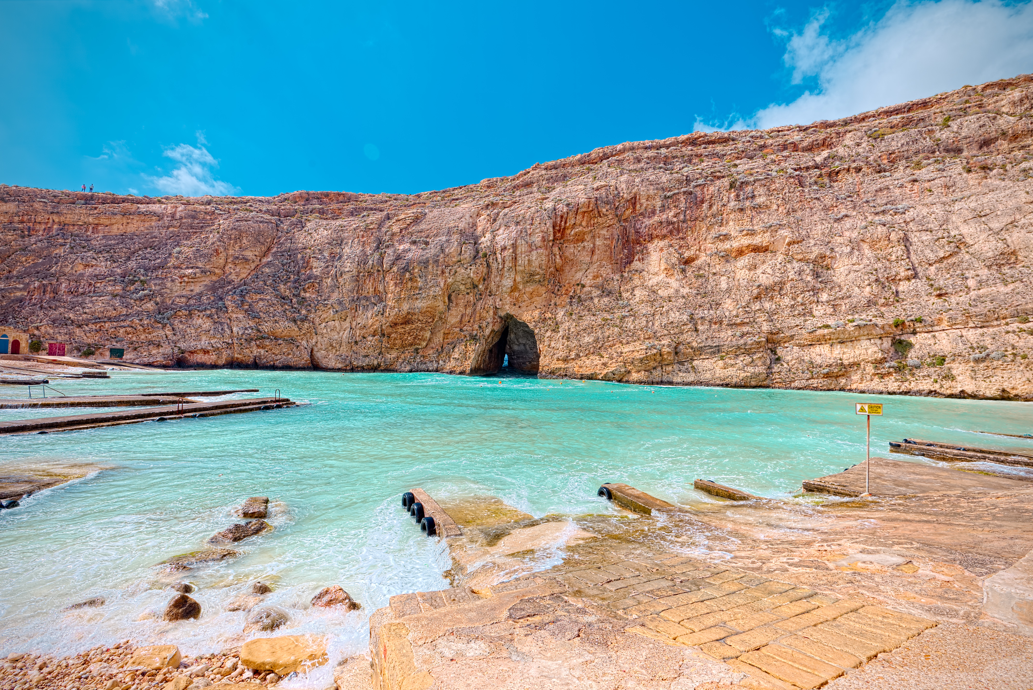 Dwejra Inland Sea, Gozo with turquoise water, rocky cliffs, and natural arch.