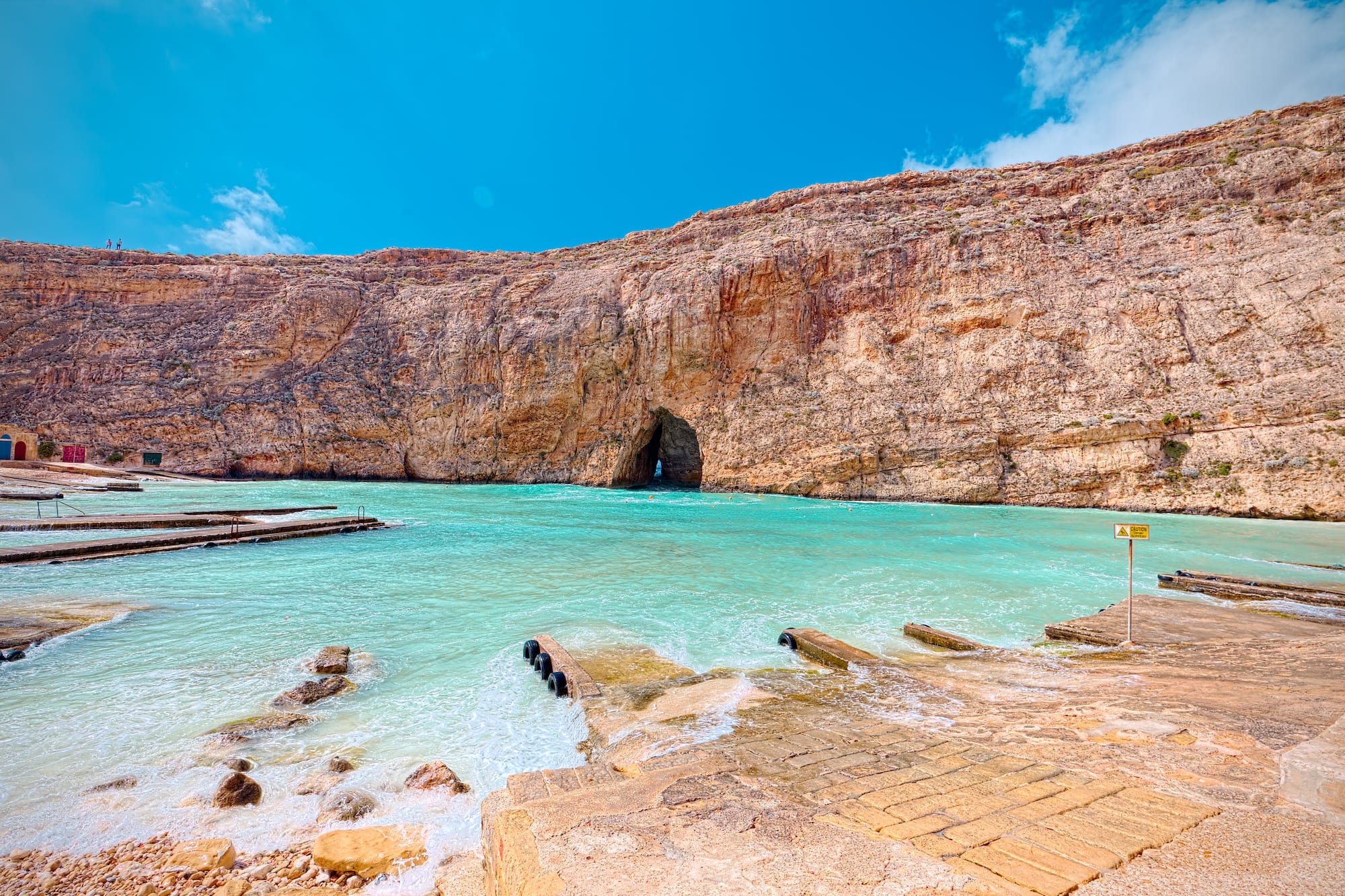 Dwejra Inland Sea, Gozo with turquoise water, rocky cliffs, and natural arch.
