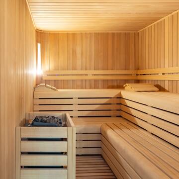 a wooden sauna with a basket and a fire in it