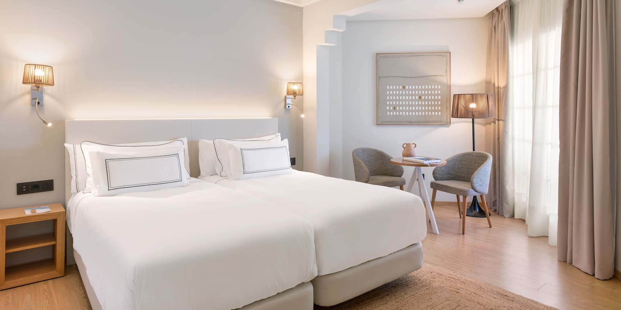 a room with a bed and a table and chairs