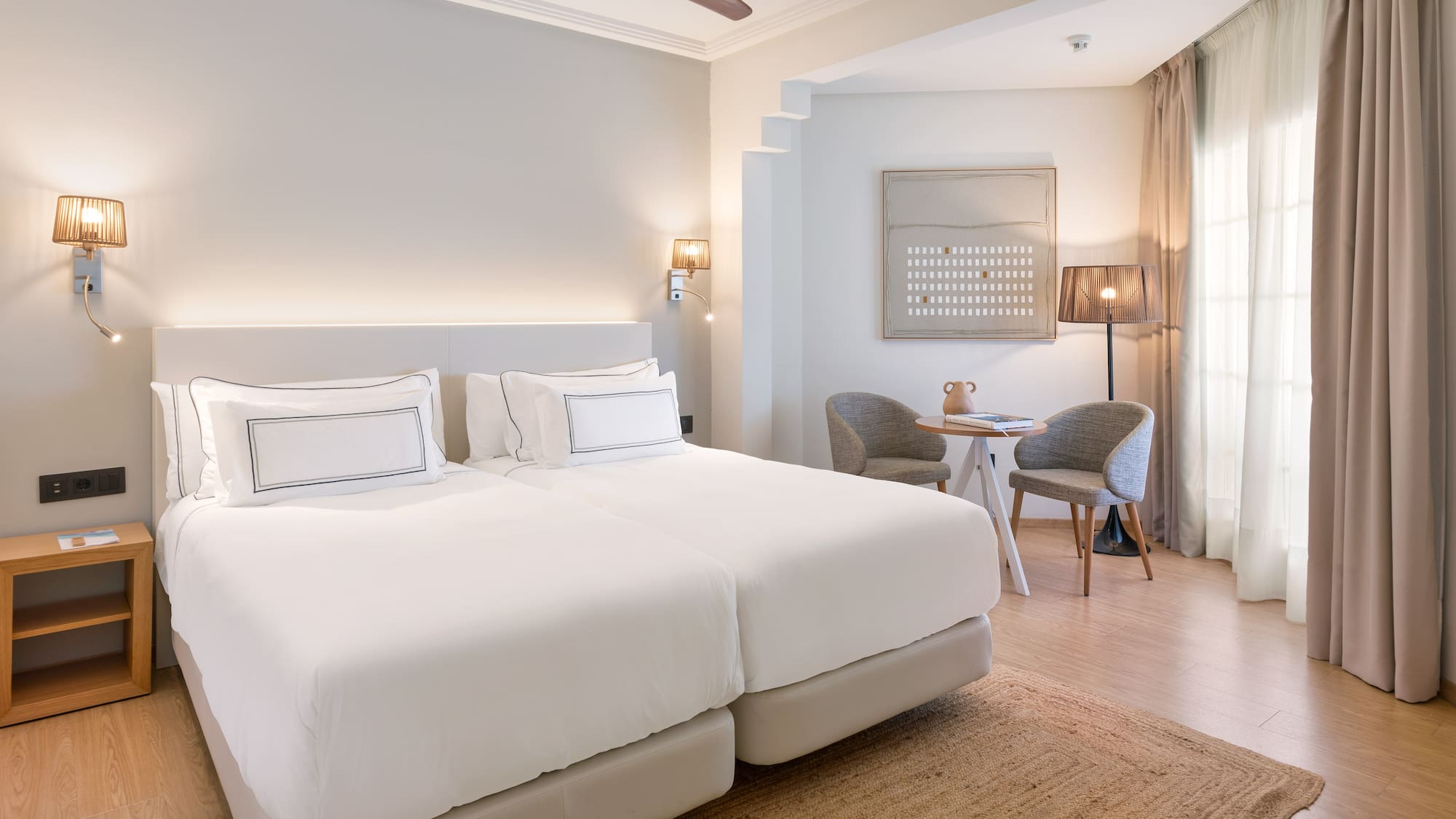 a room with a bed and a table and chairs