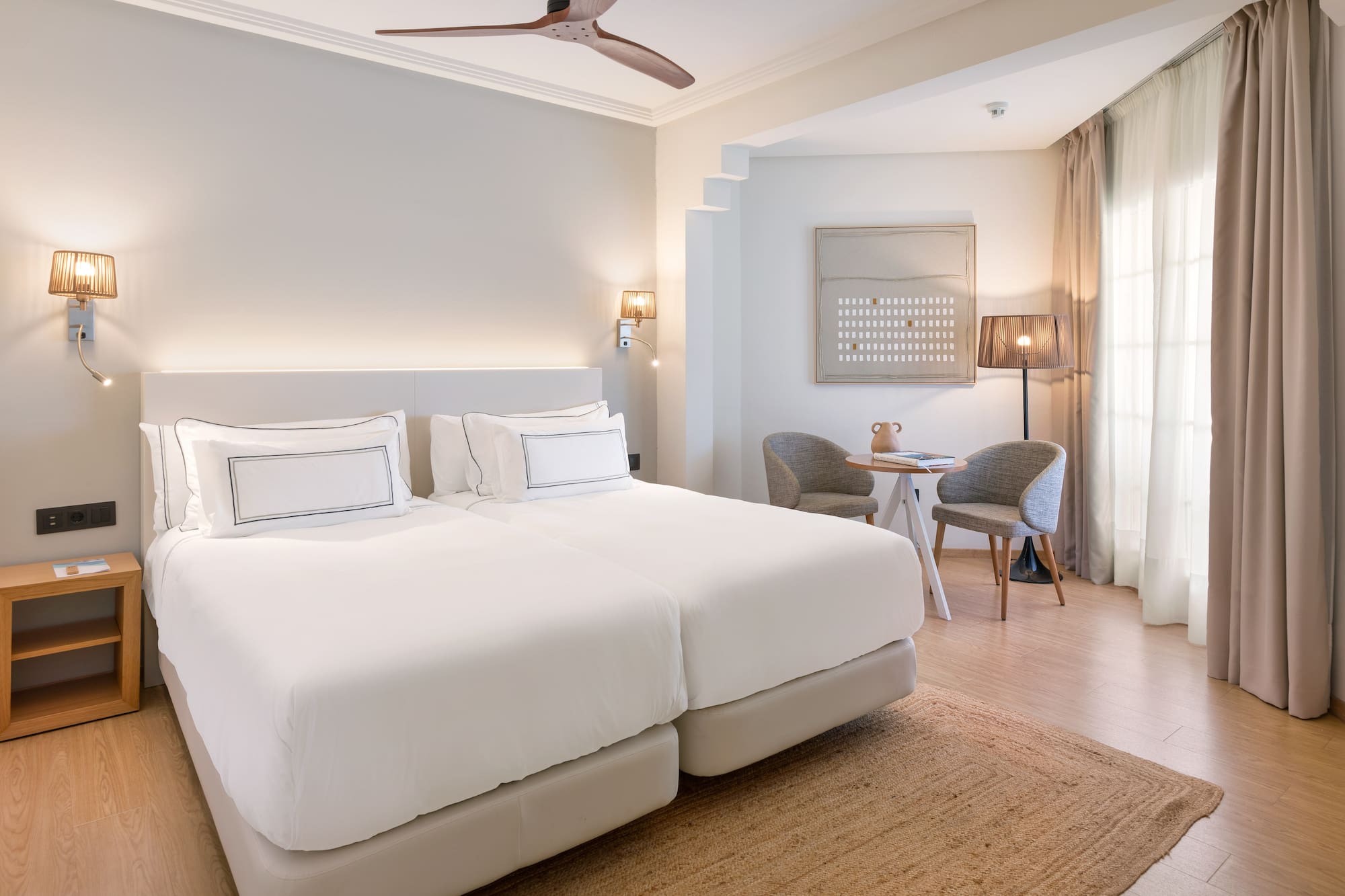 a room with a bed and a table and chairs