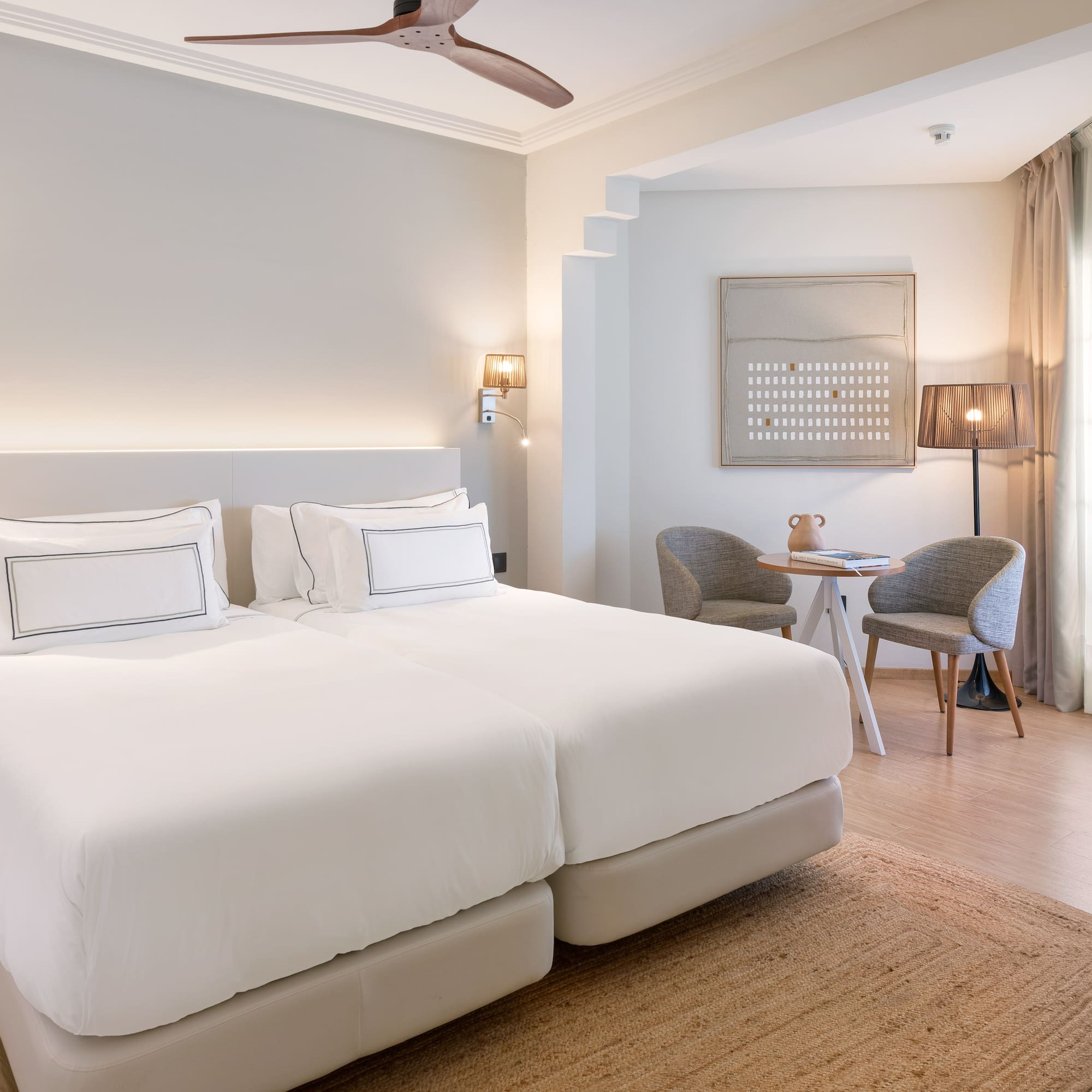 a room with a bed and a table and chairs