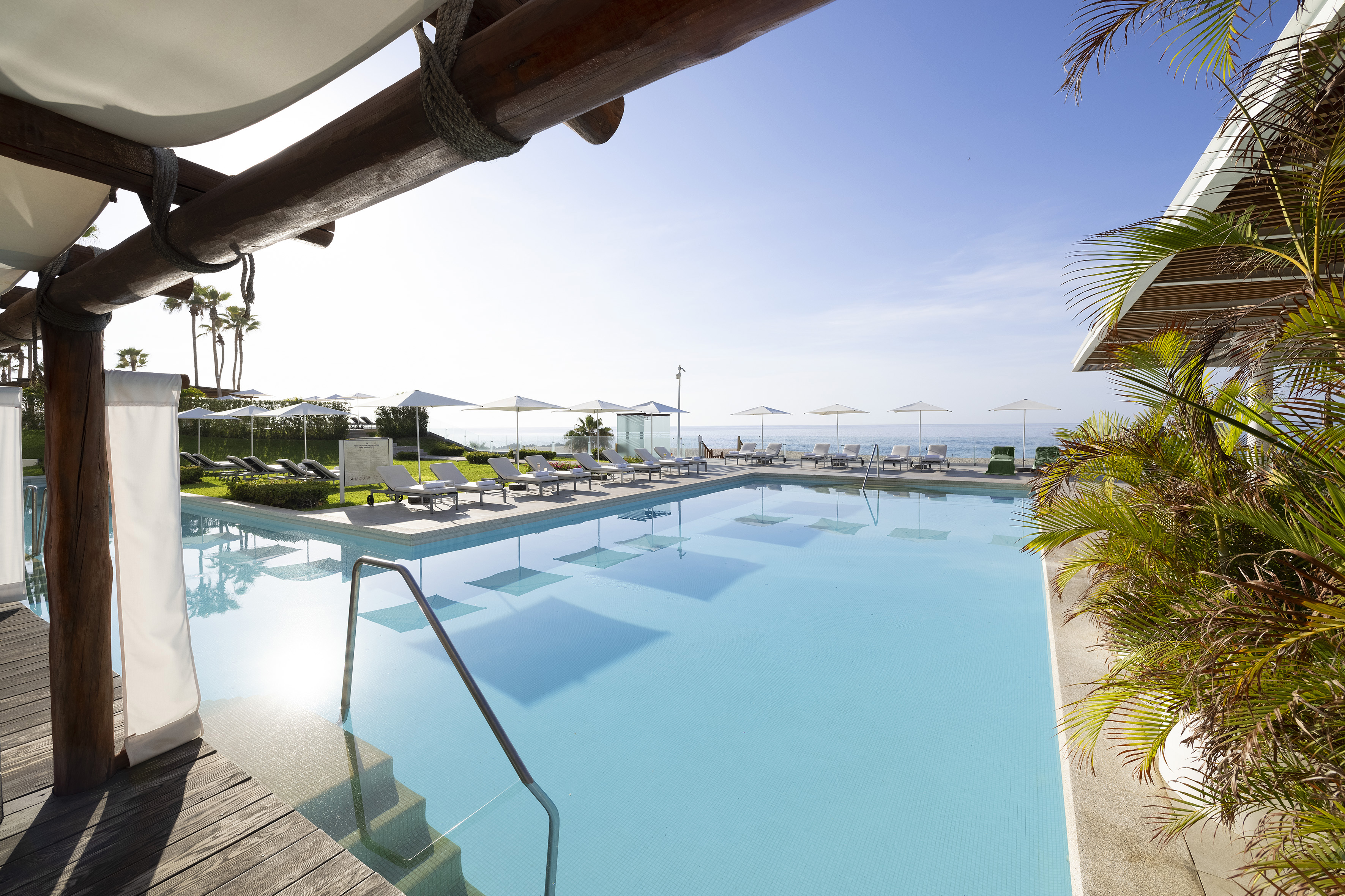 a pool with chairs and umbrellas
