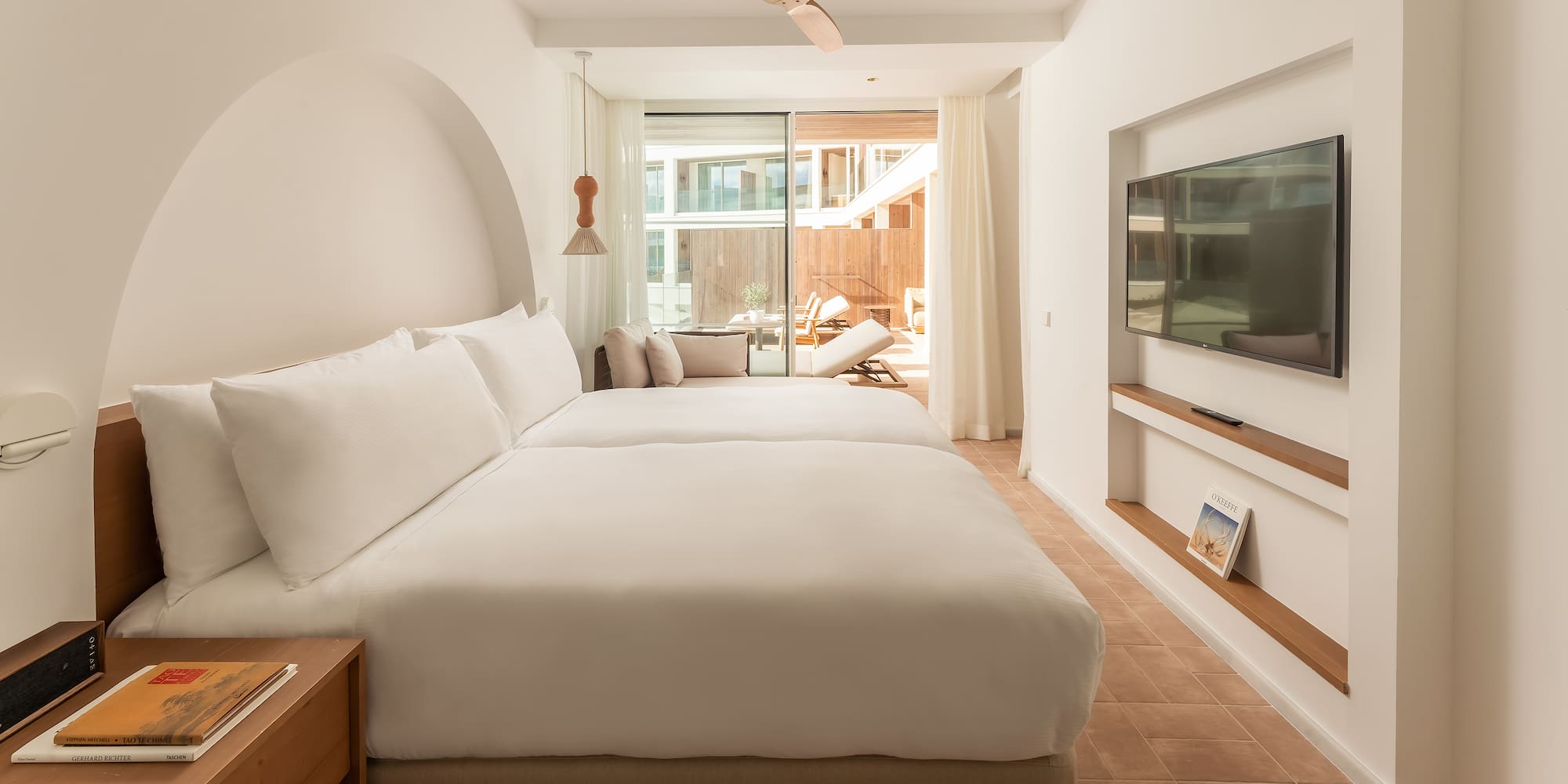 a room with a bed and a television