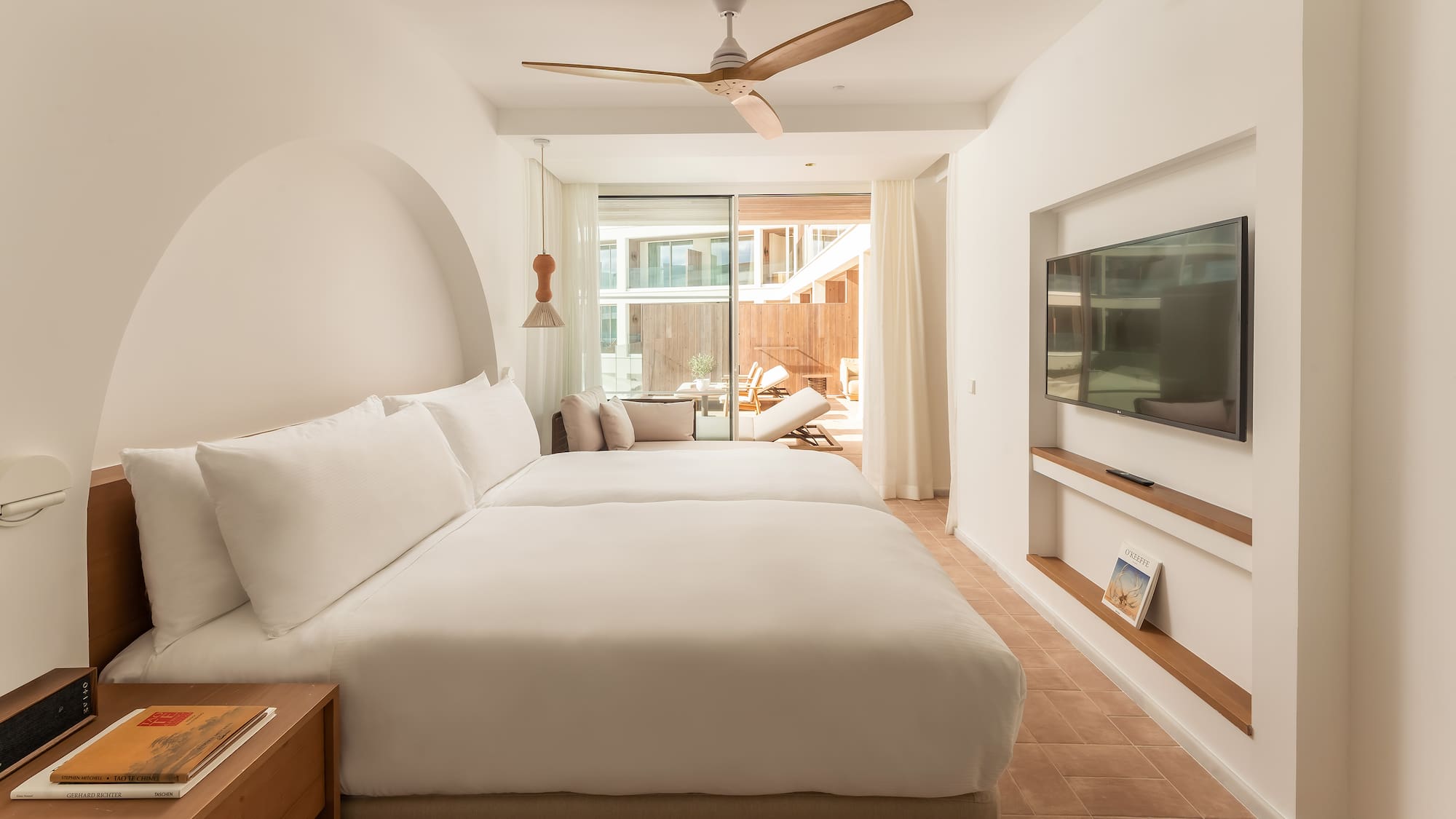 a room with a bed and a television