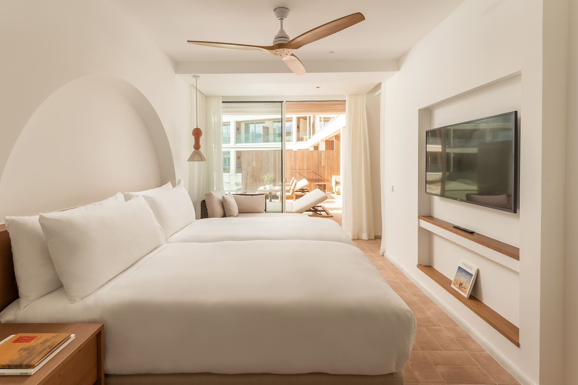 a room with a bed and a television