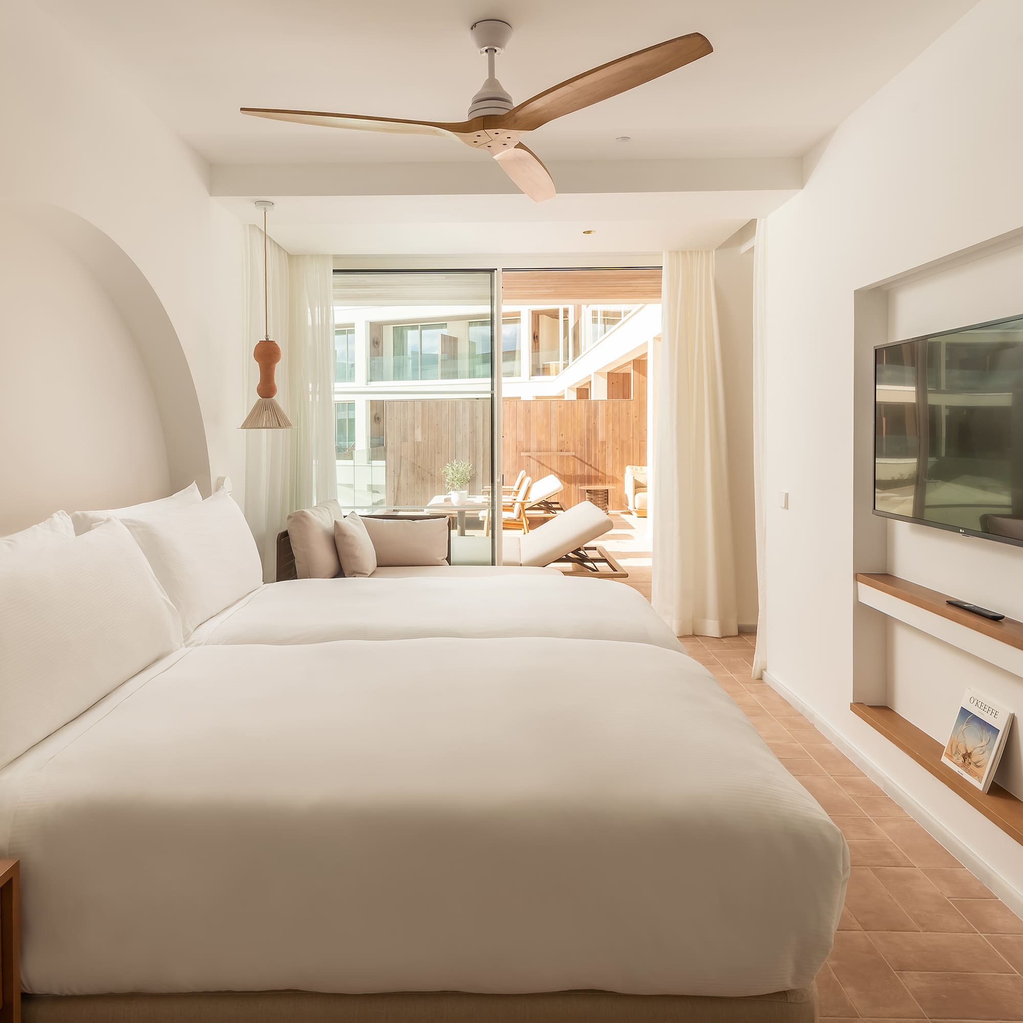 a room with a bed and a television