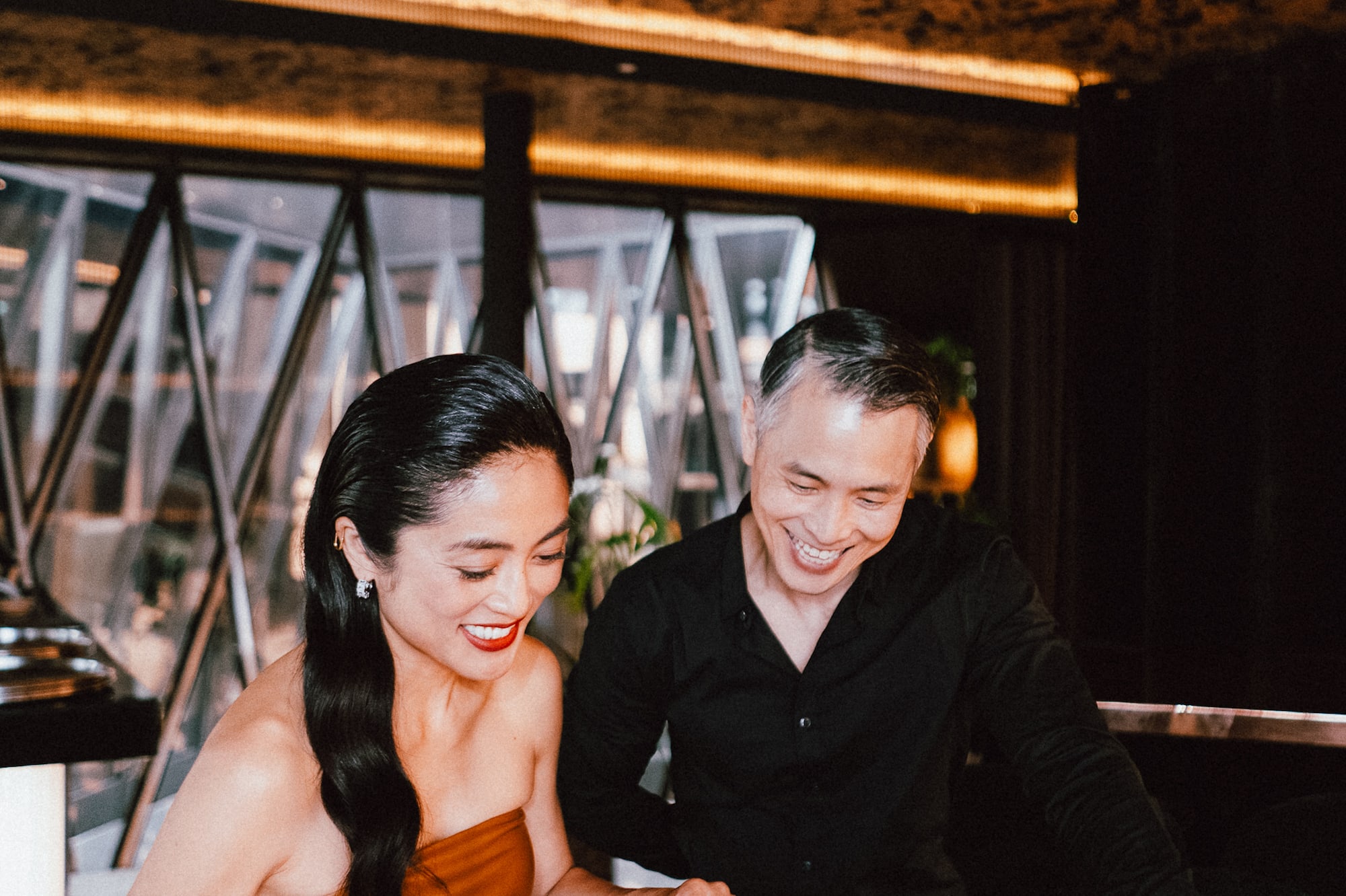 a man and woman looking at a book