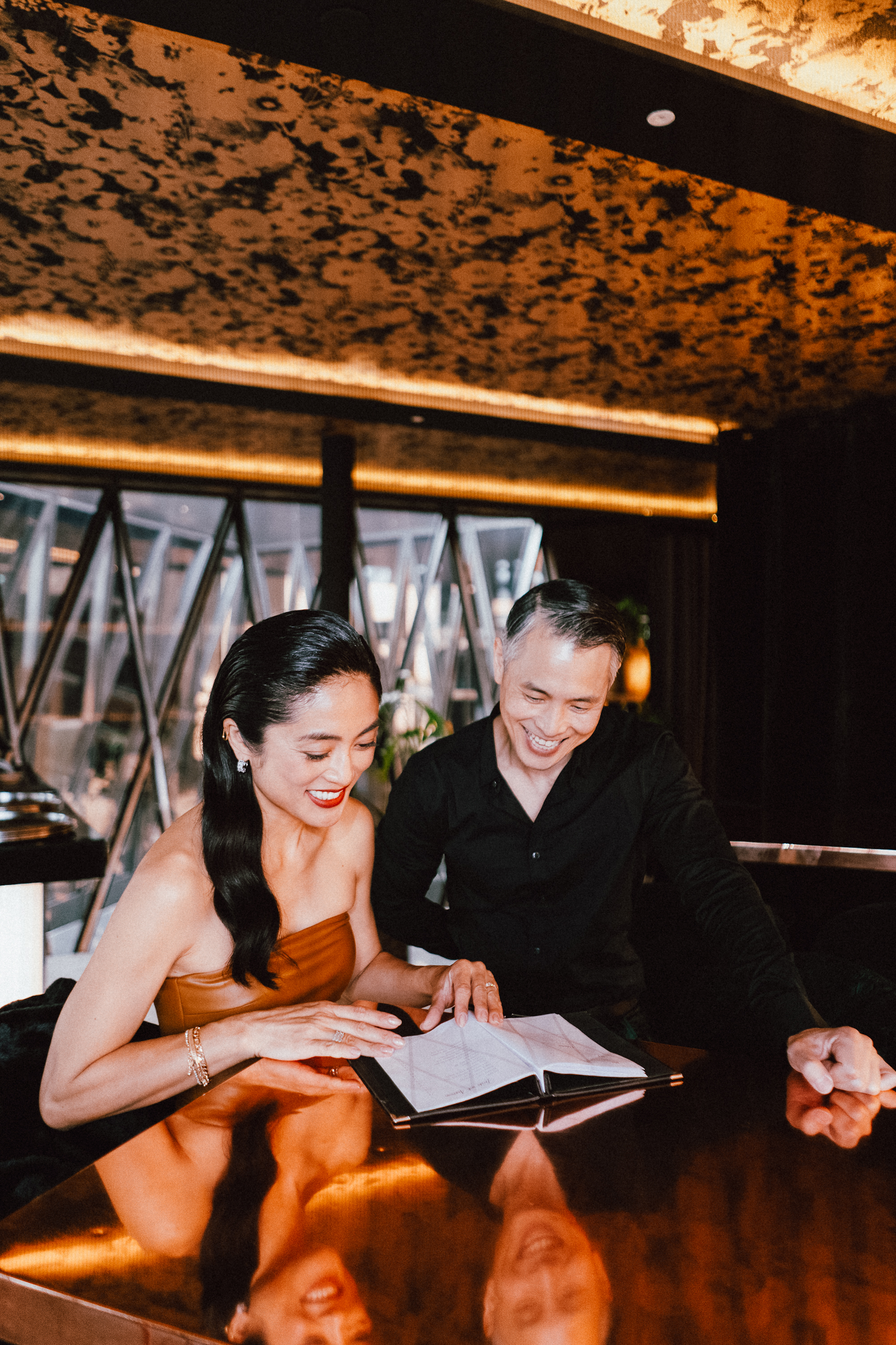 a man and woman looking at a book