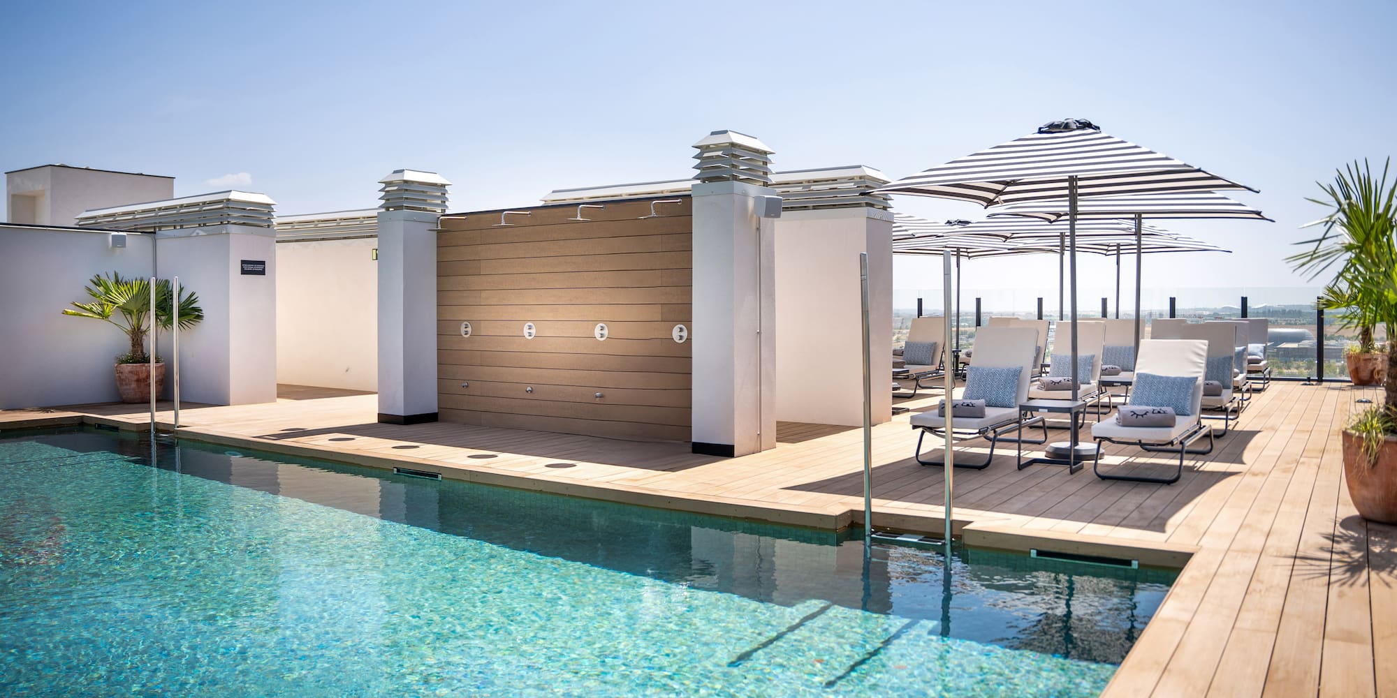 a pool with chairs and umbrellas