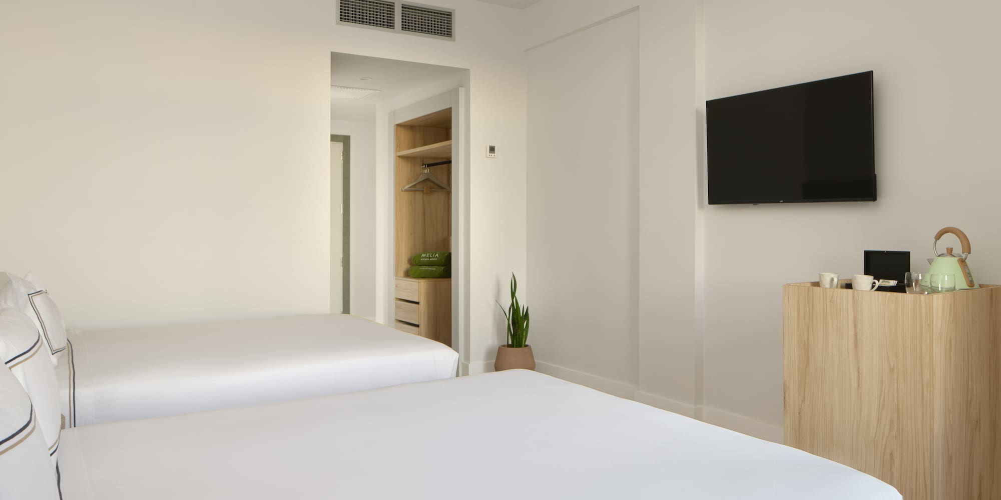 a room with two beds and a tv