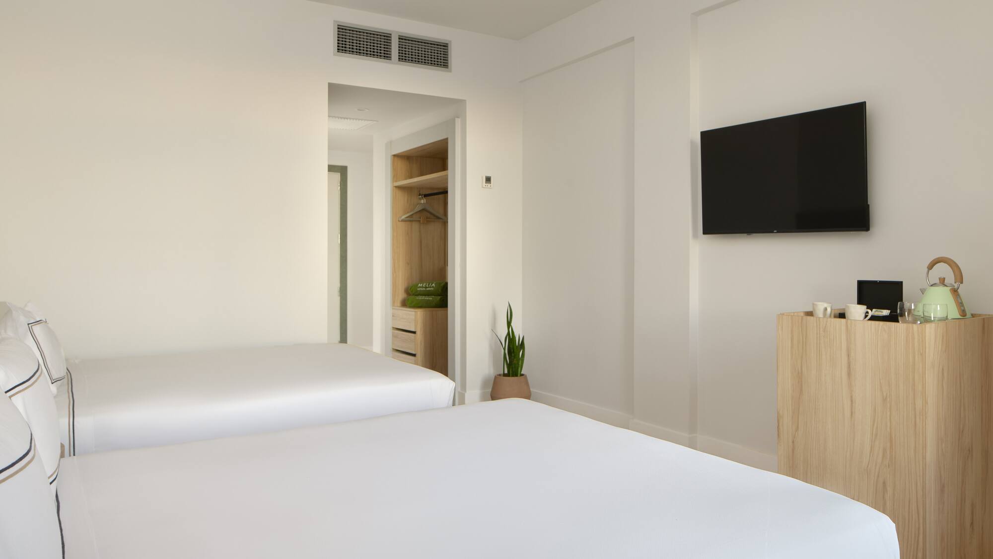 a room with two beds and a tv