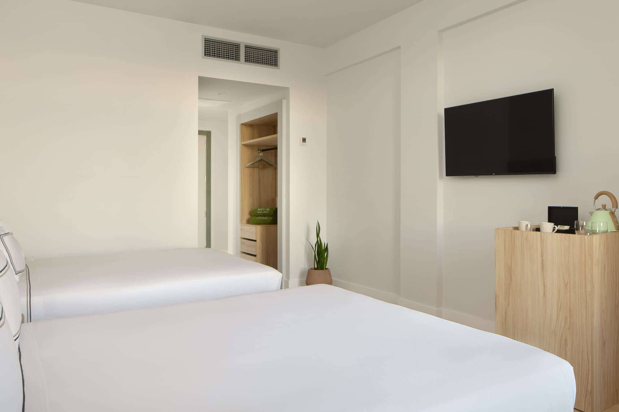 a room with two beds and a tv