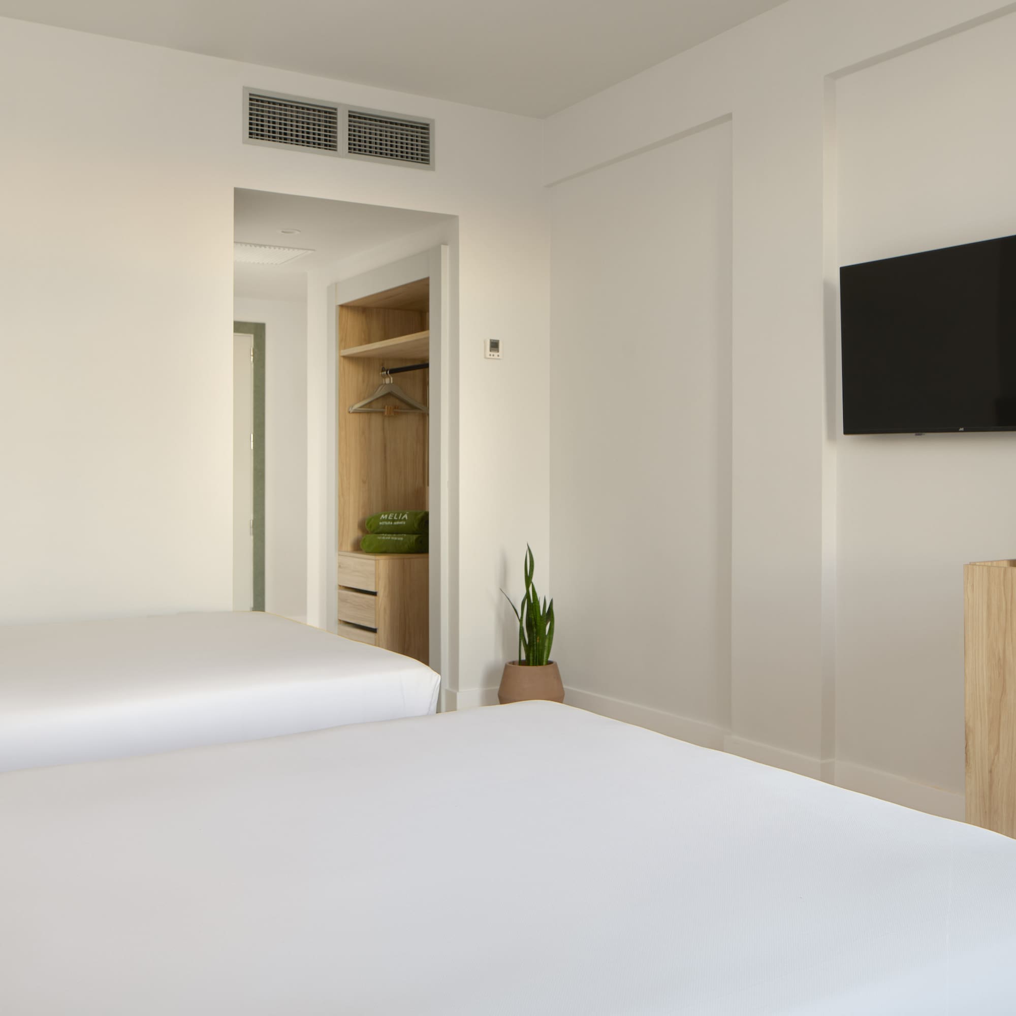 a room with two beds and a tv