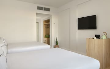 a room with two beds and a tv