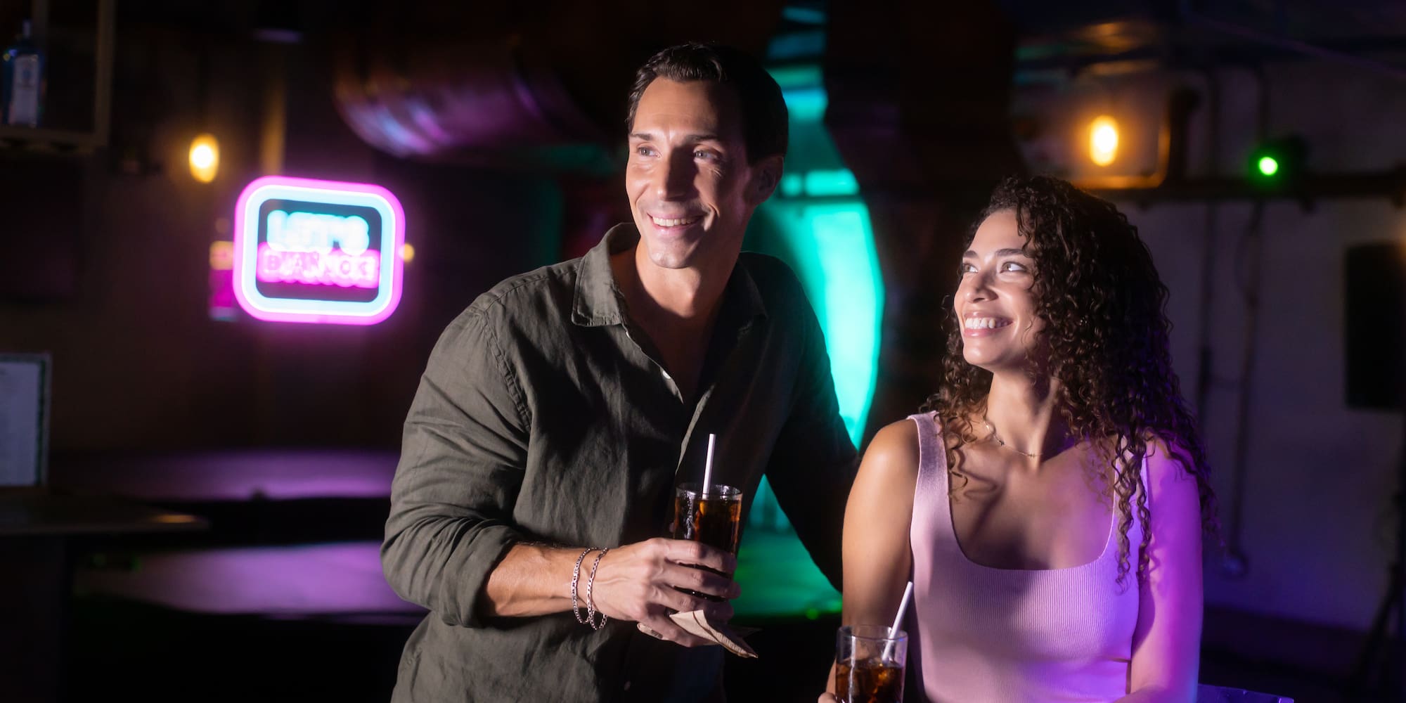 a man and woman holding drinks