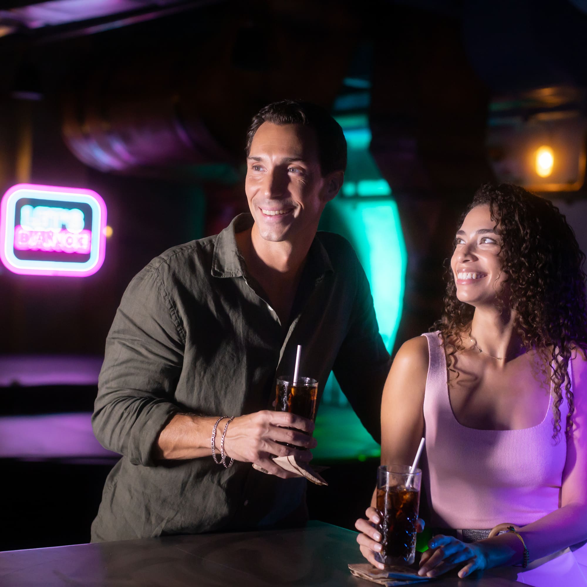 a man and woman holding drinks