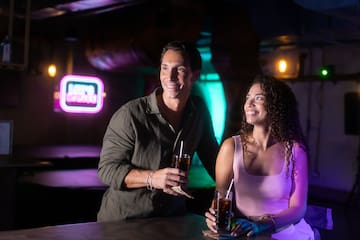 a man and woman holding drinks