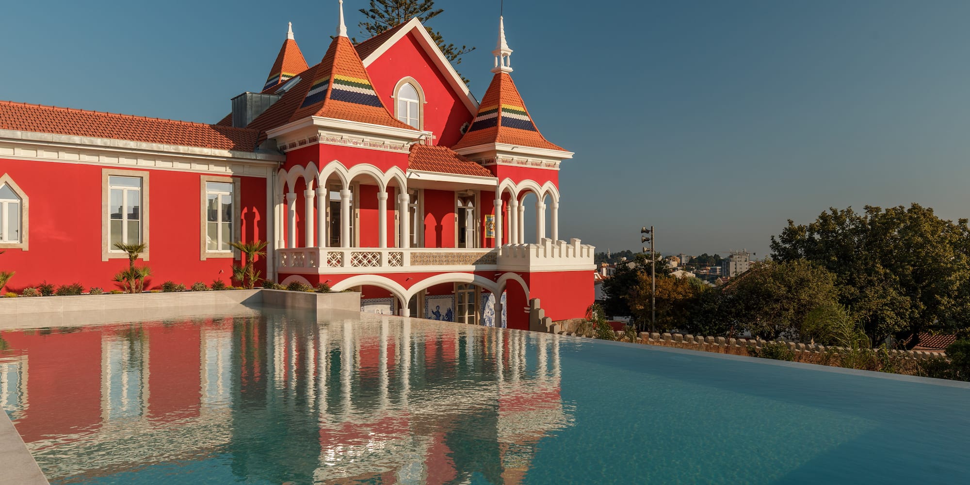 a pool of water next to a red house