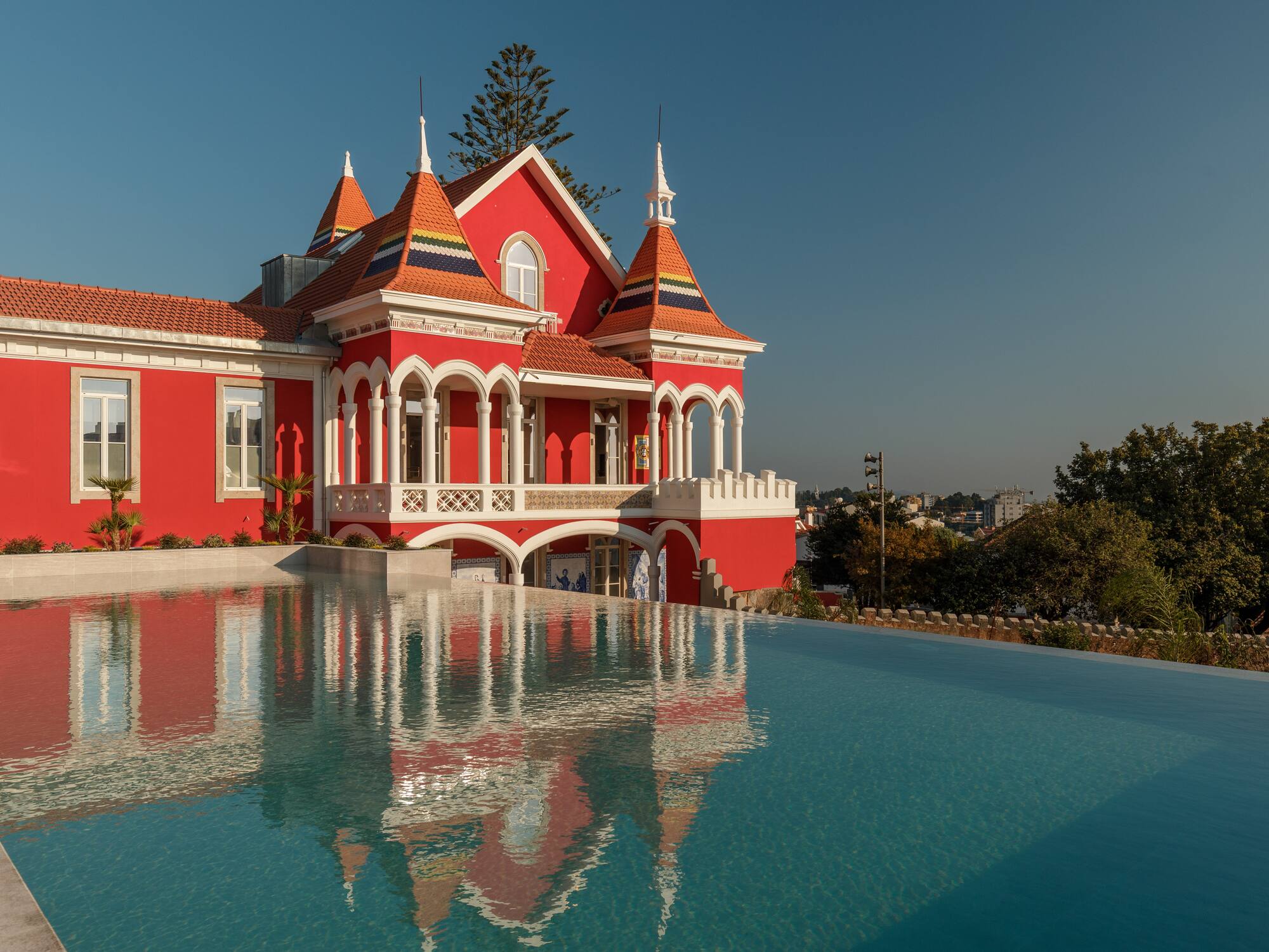 a pool of water next to a red house