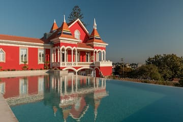 a pool of water next to a red house