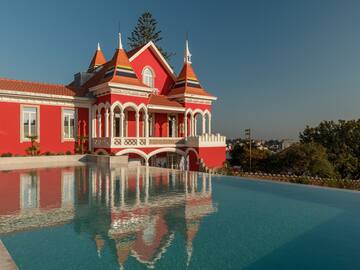 a pool of water next to a red house