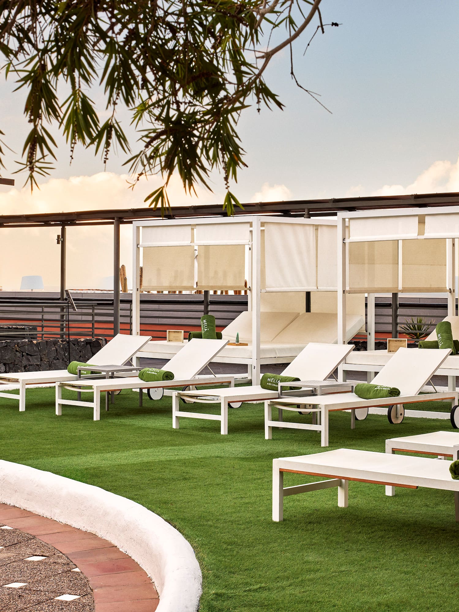a group of lounge chairs on a green lawn