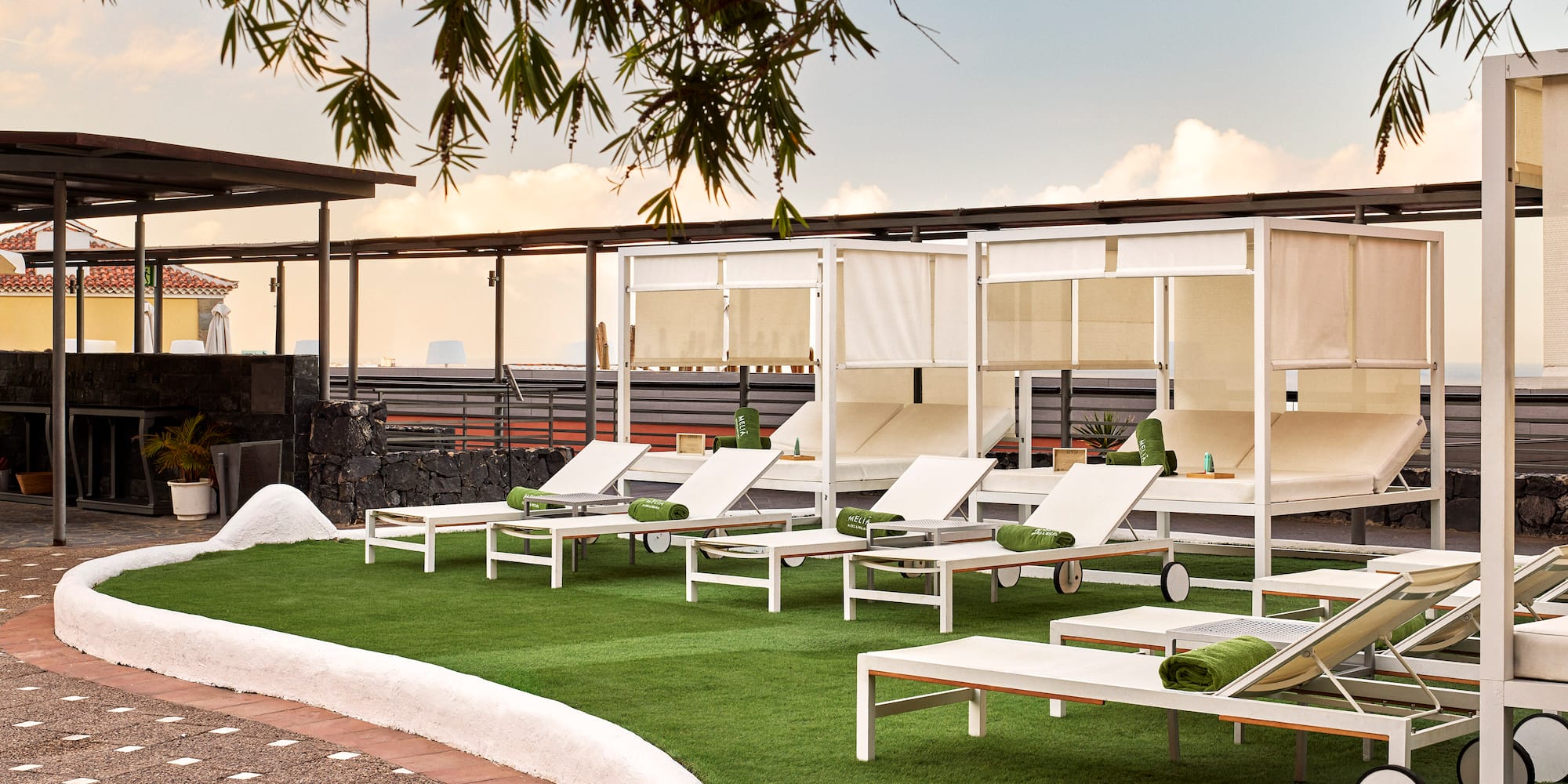 a group of lounge chairs on a green lawn