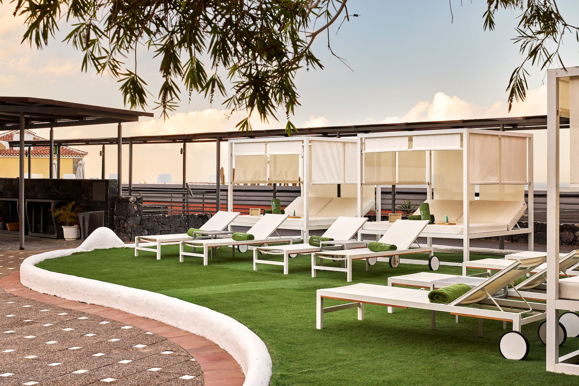 a group of lounge chairs on a green lawn