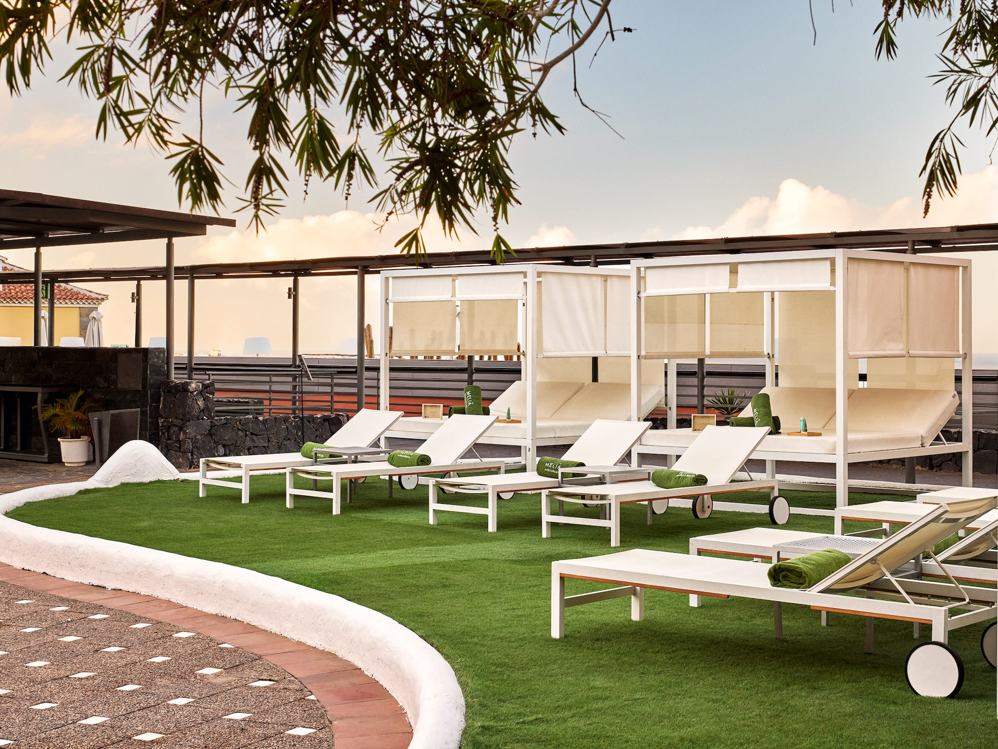 a group of lounge chairs on a green lawn