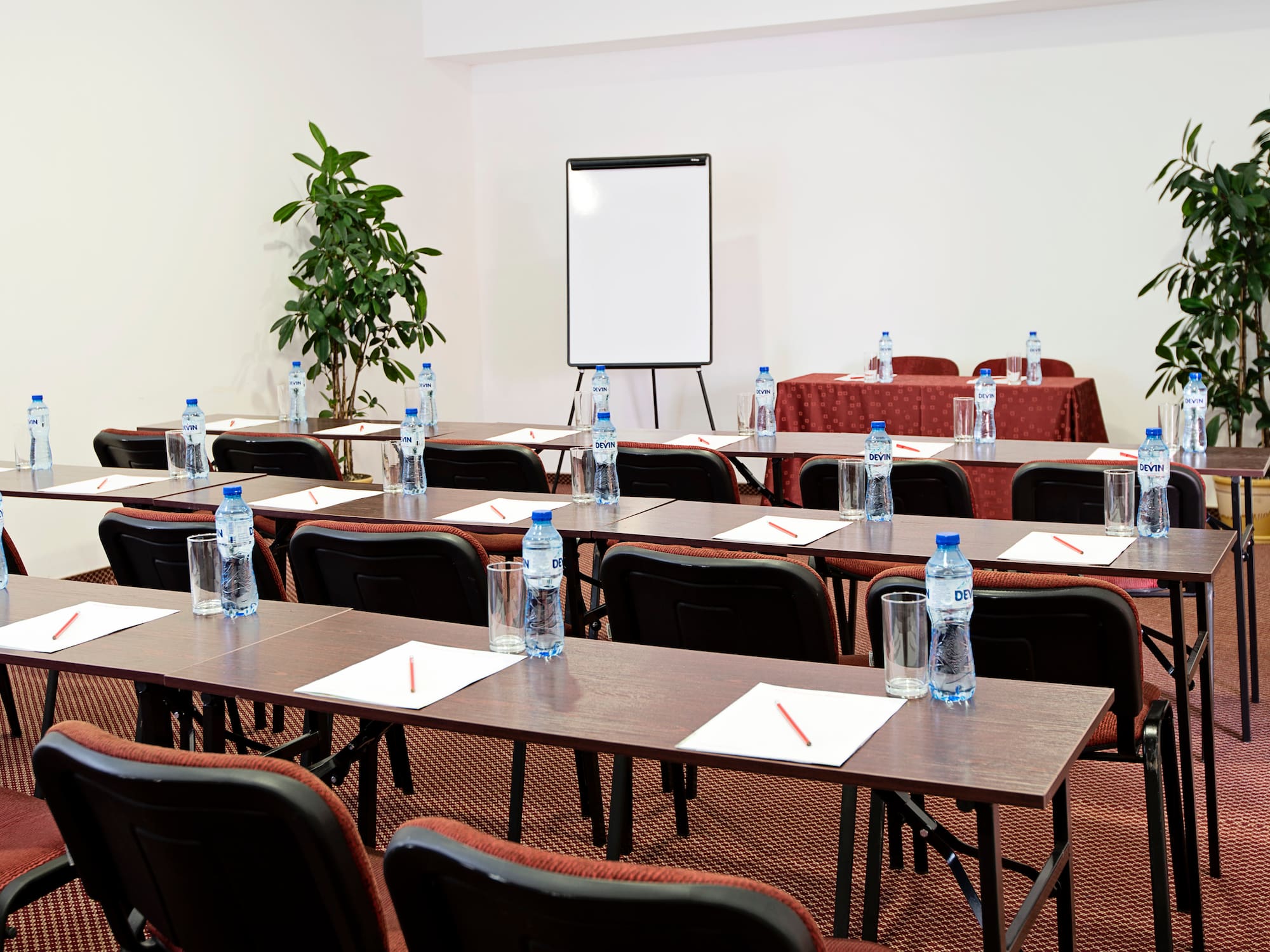 a room with tables and chairs and a white board