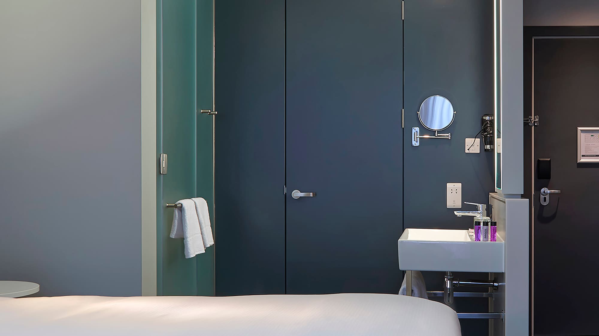 a room with two beds and a sink