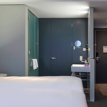 a room with two beds and a sink
