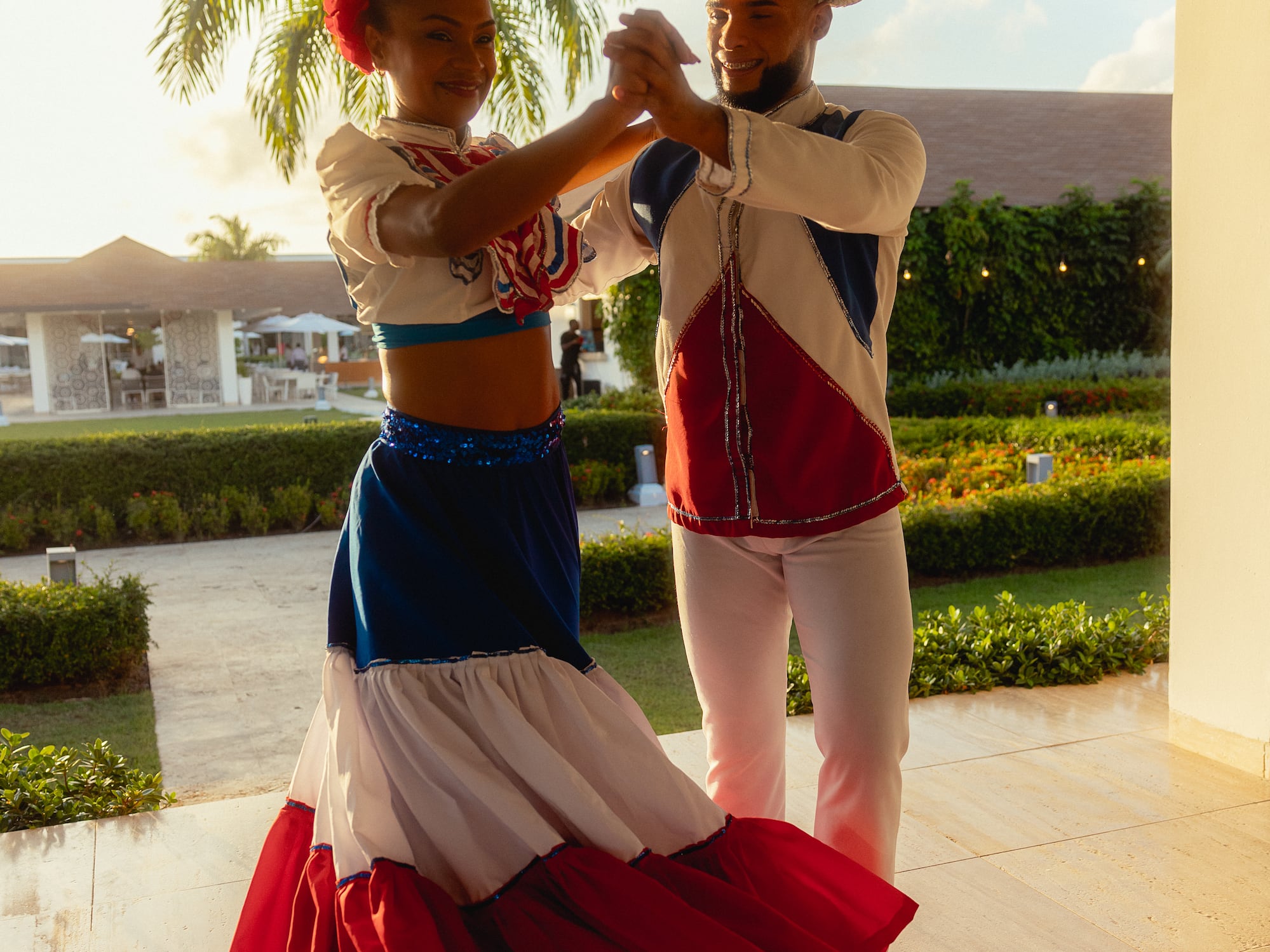 a man and woman dancing in a white and red dress