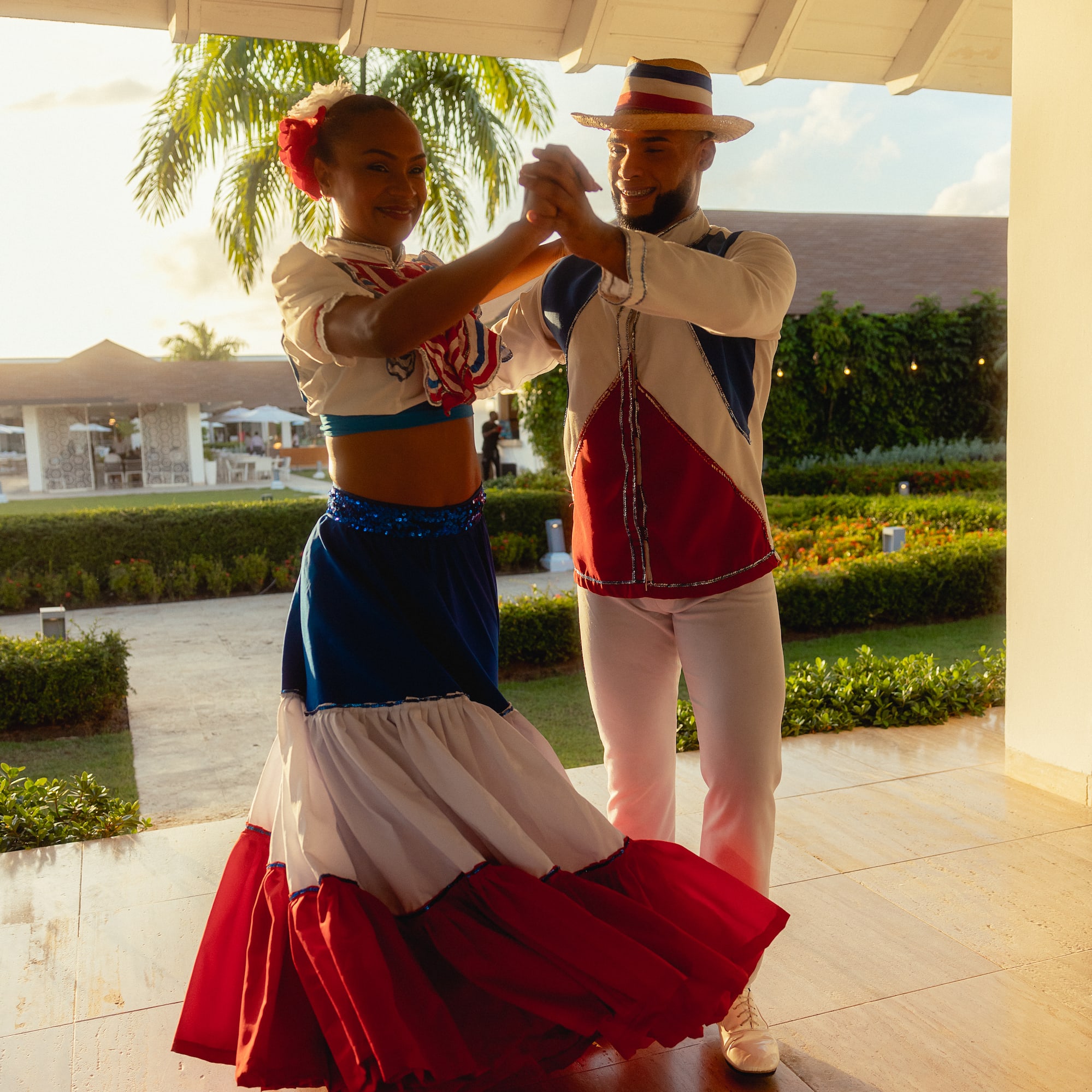 a man and woman dancing in a white and red dress