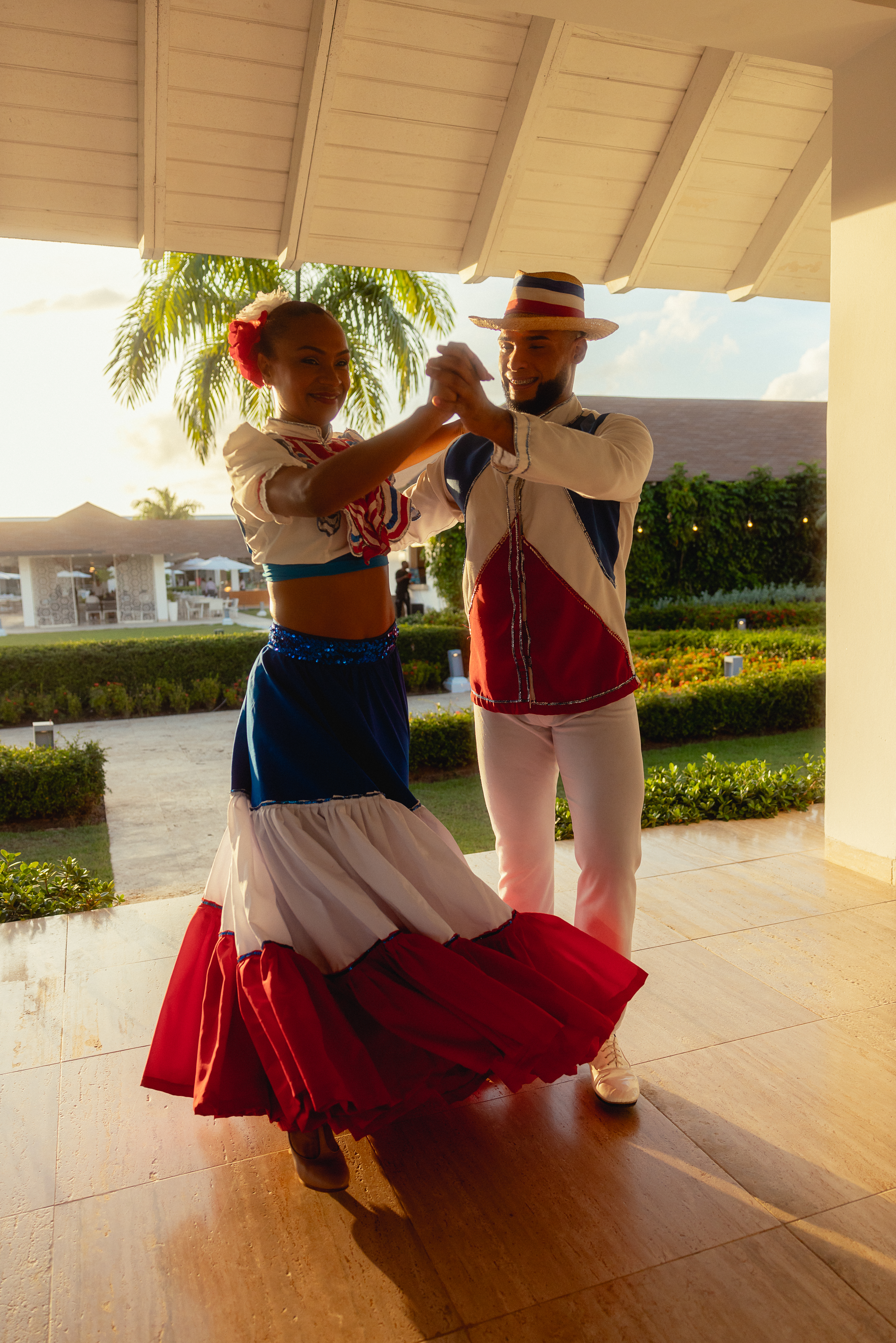 a man and woman dancing in a white and red dress