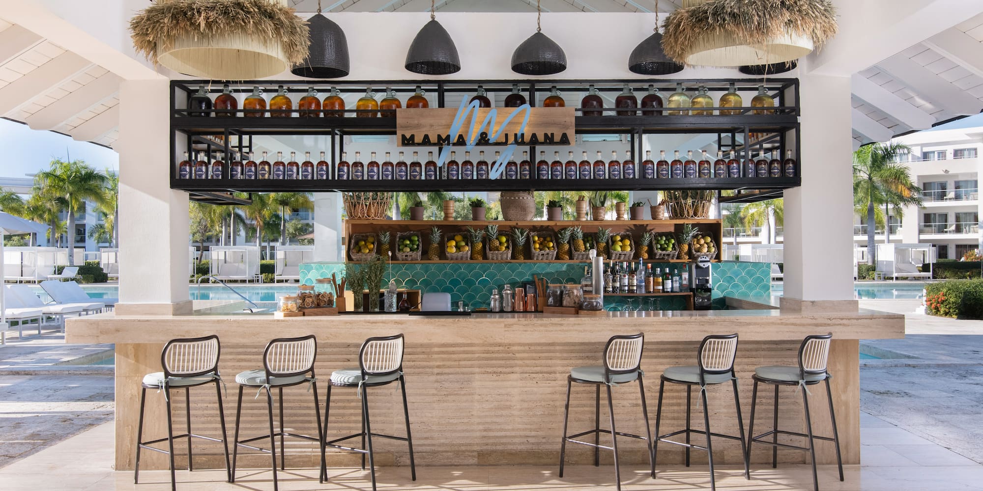 Mama & Juana tropical bar by pool, custom spirits, fresh fruit.