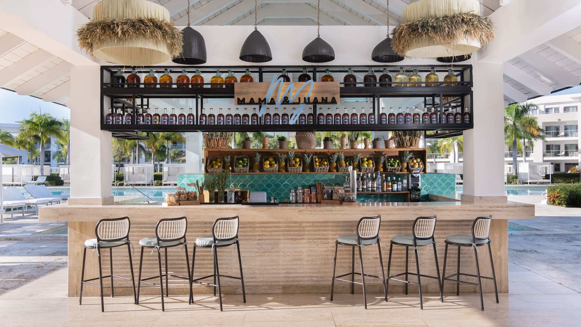 Mama & Juana tropical bar by pool, custom spirits, fresh fruit.