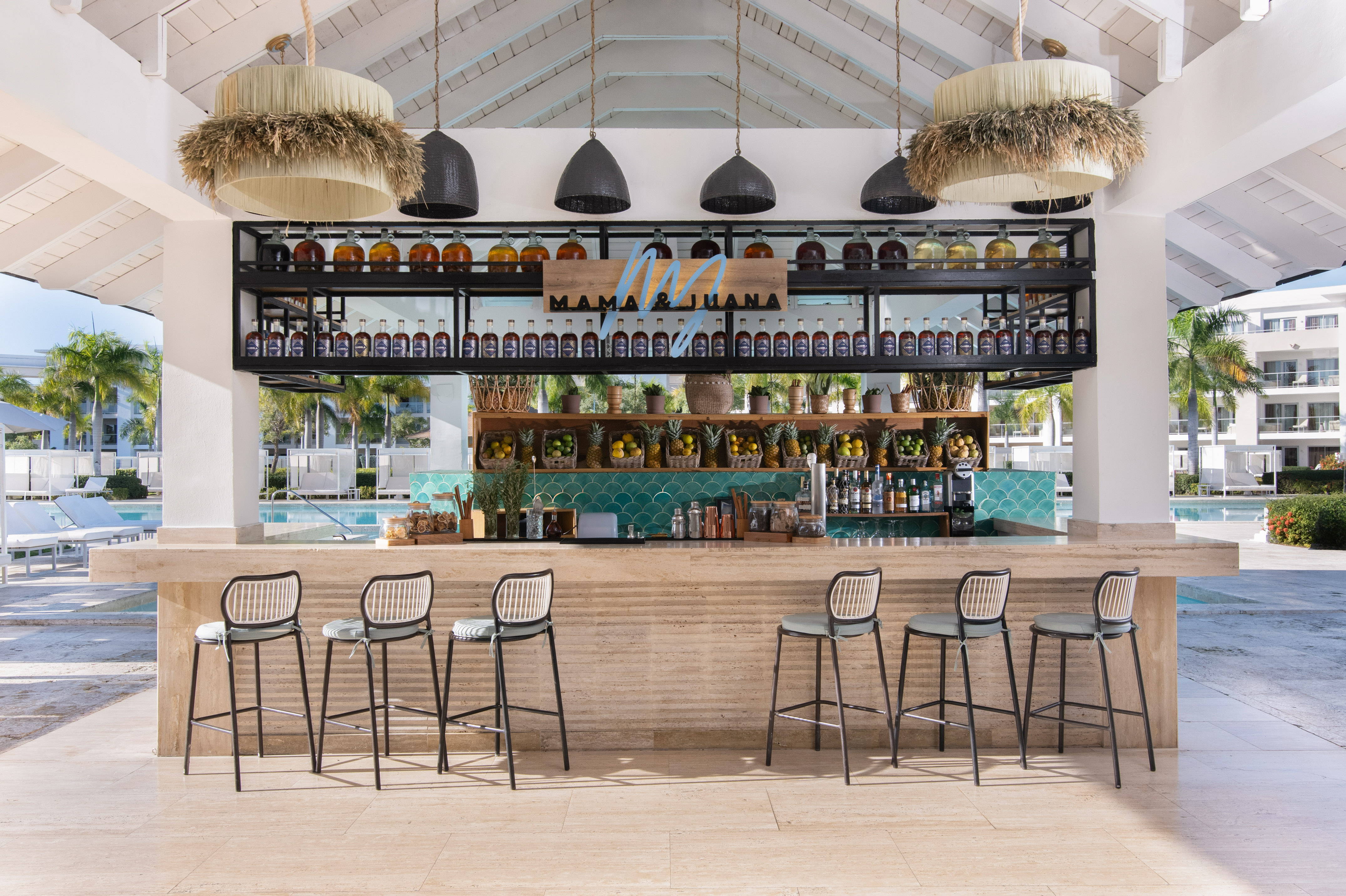 Mama & Juana tropical bar by pool, custom spirits, fresh fruit.