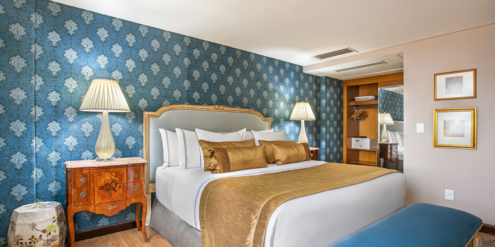 a bedroom with a bed and a blue wallpaper