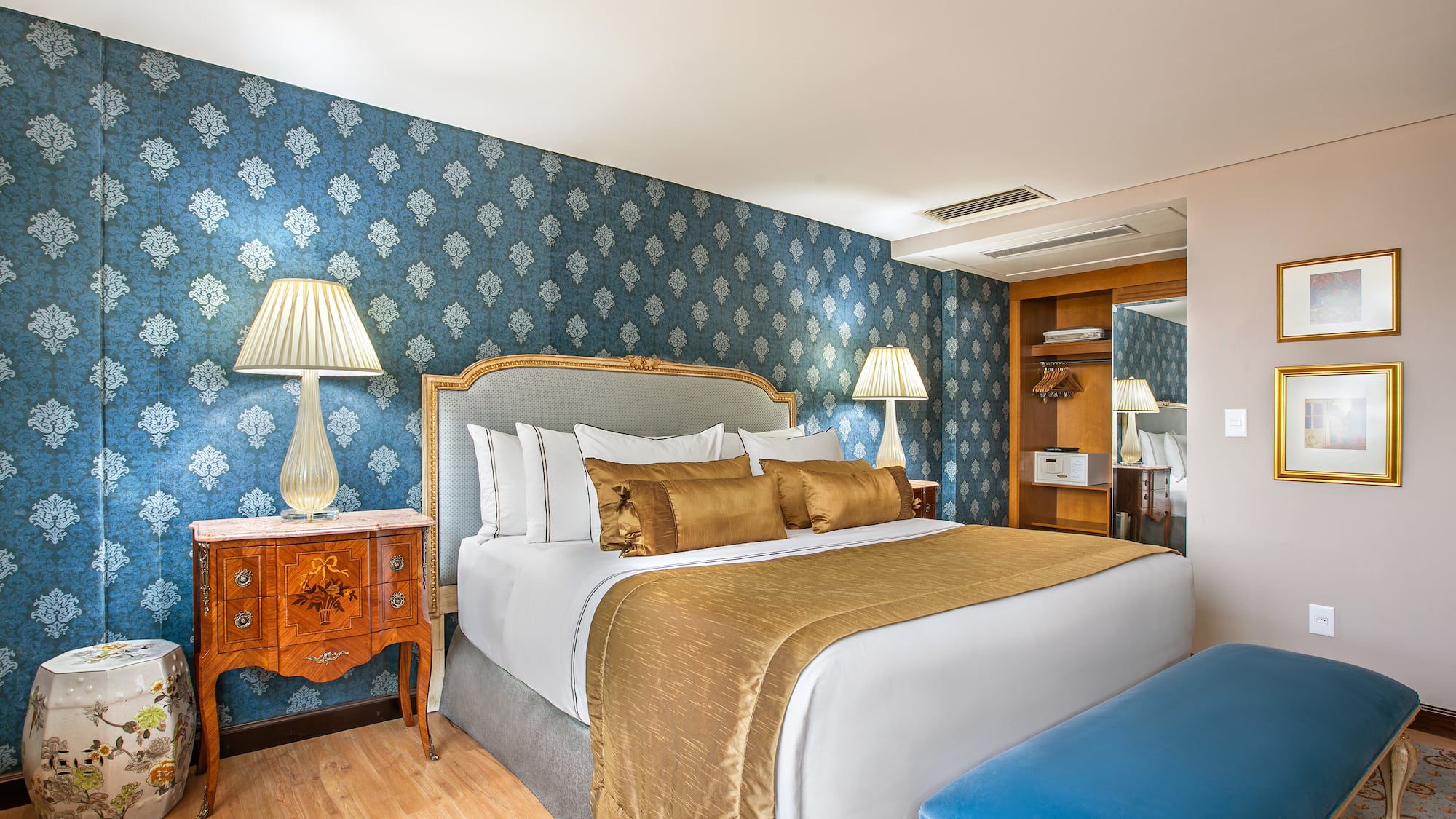 a bedroom with a bed and a blue wallpaper