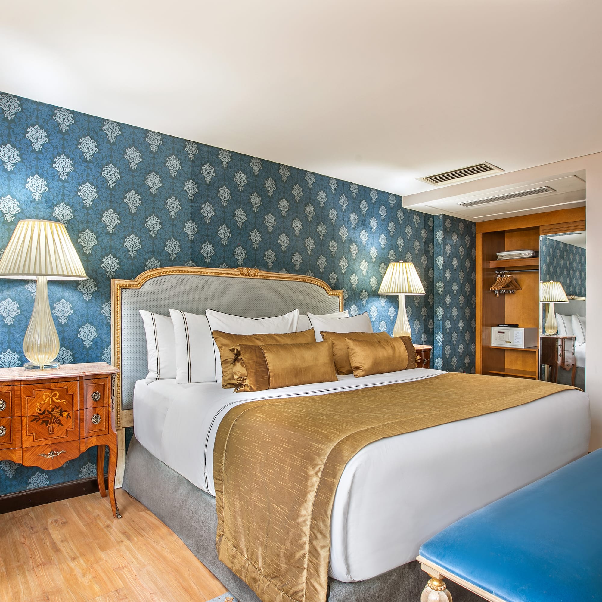 a bedroom with a bed and a blue wallpaper