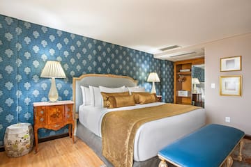 a bedroom with a bed and a blue wallpaper