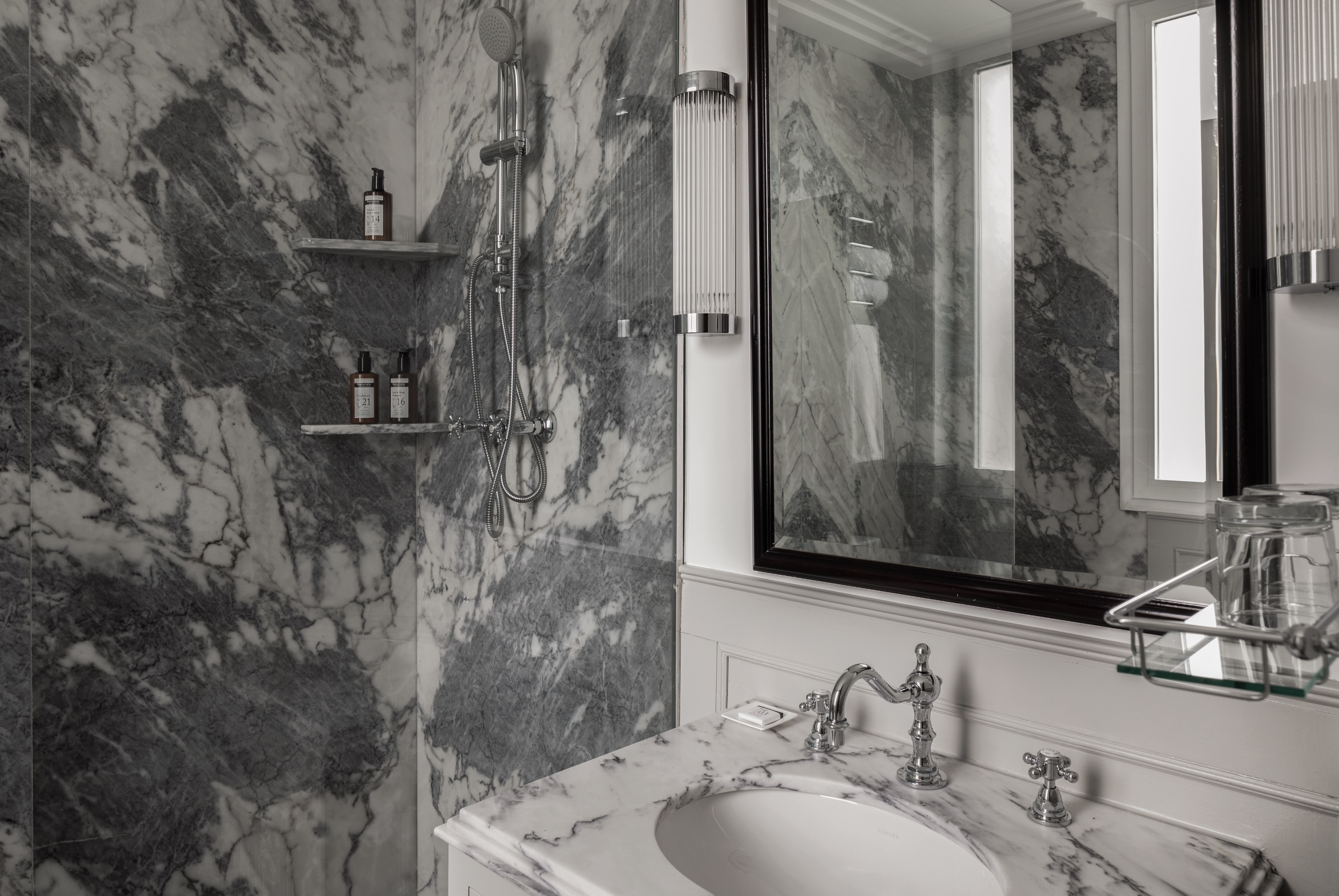 a bathroom with a mirror and sink