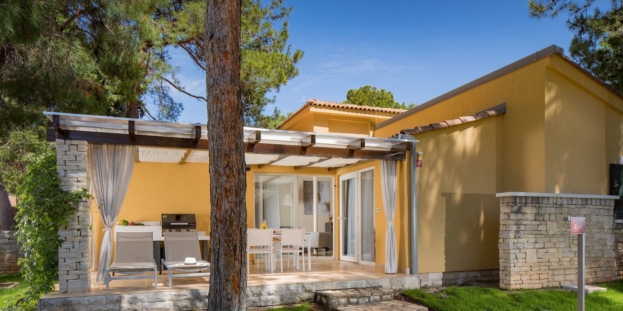 a house with a patio and a tree