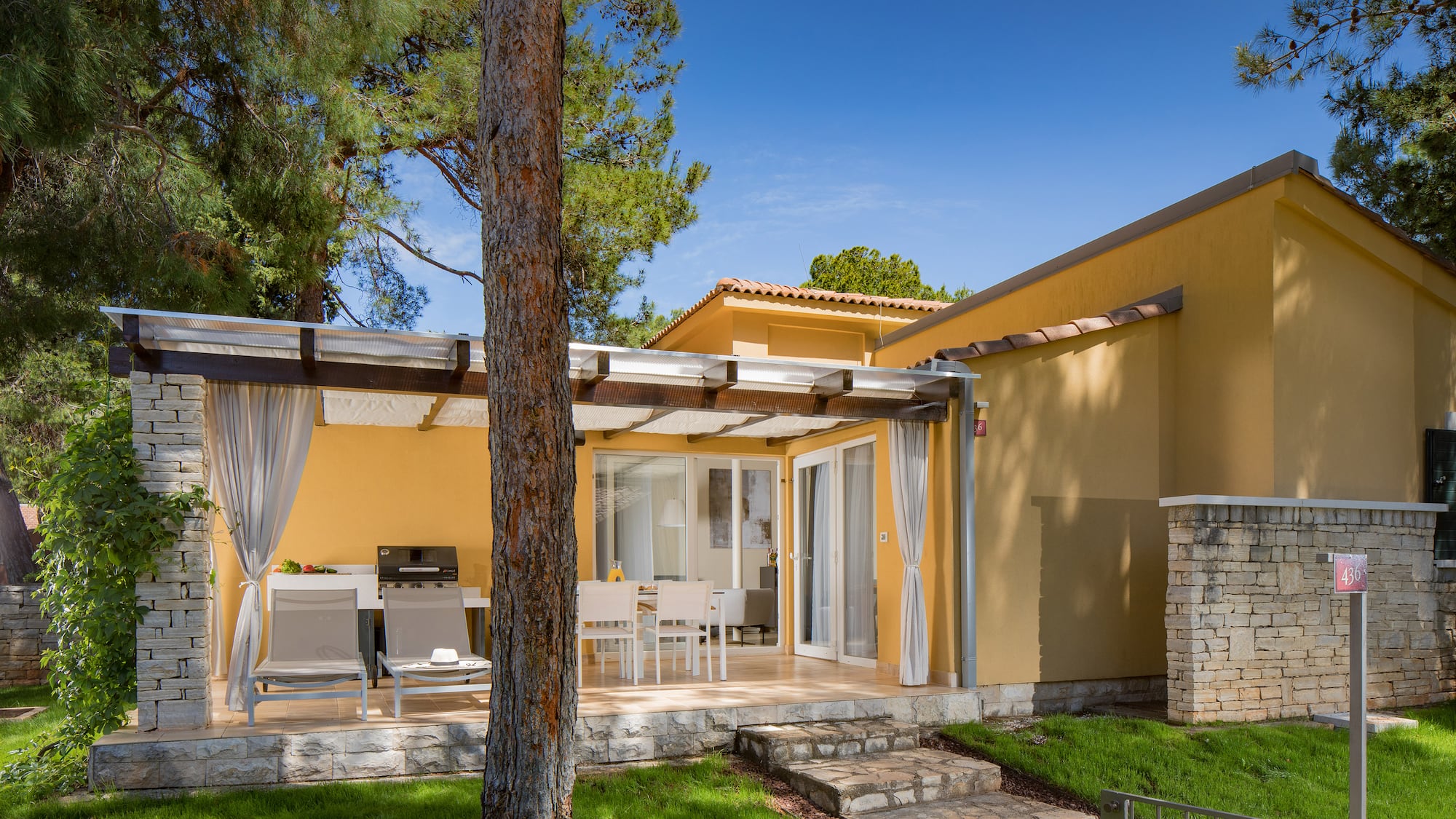 a house with a patio and a tree