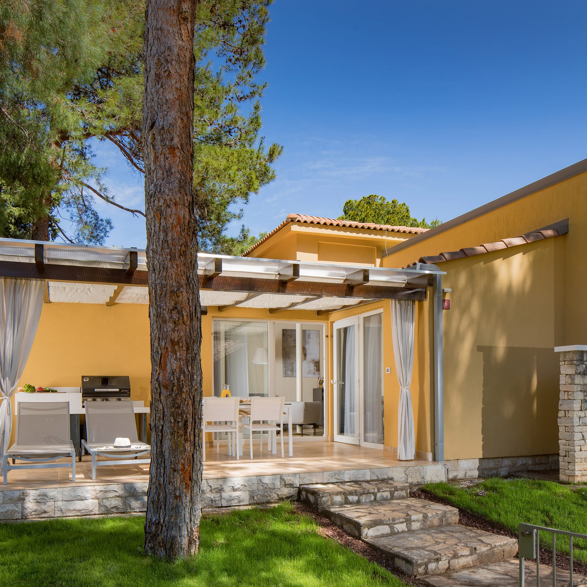 a house with a patio and a tree