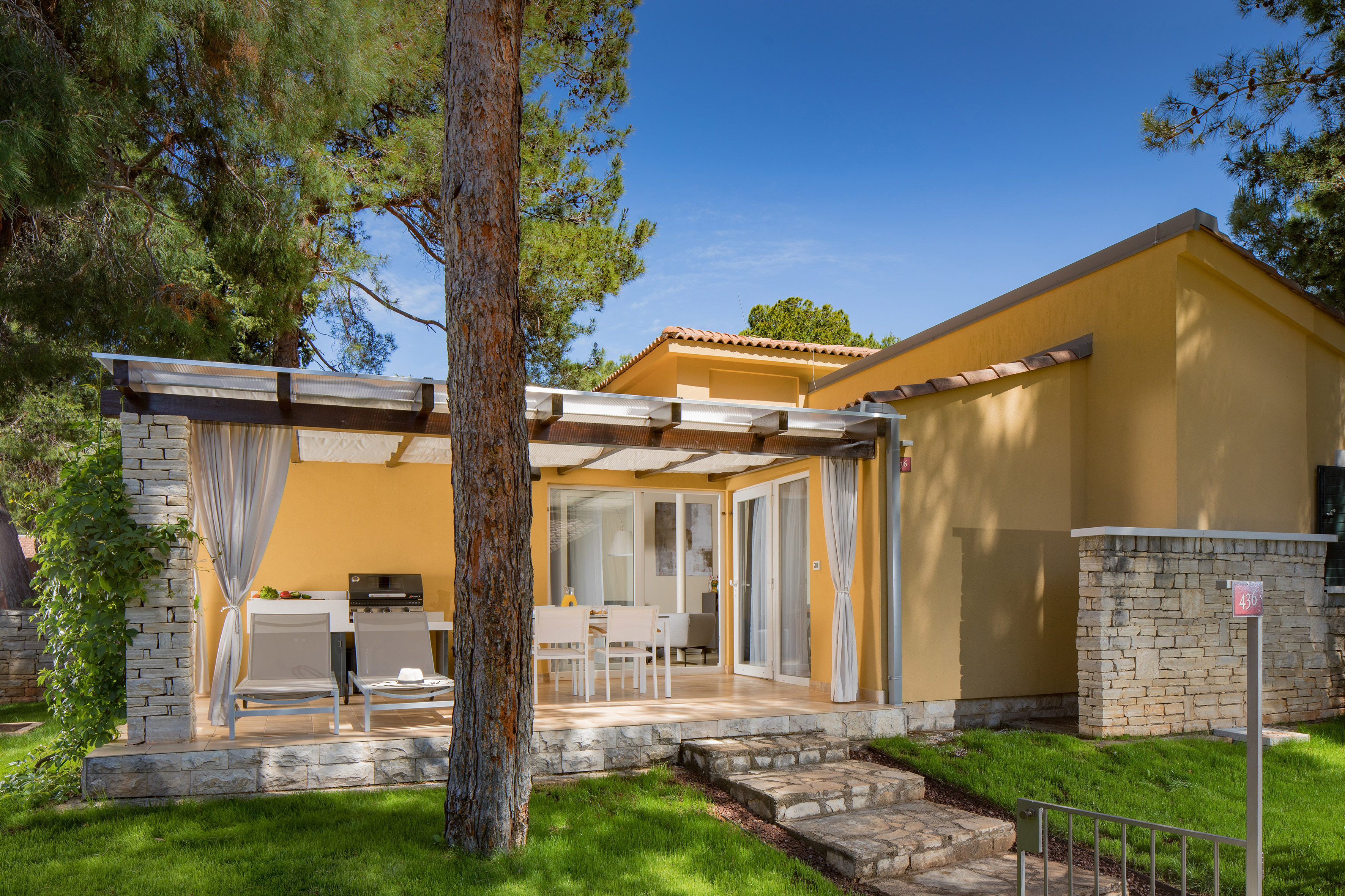 a house with a patio and a tree
